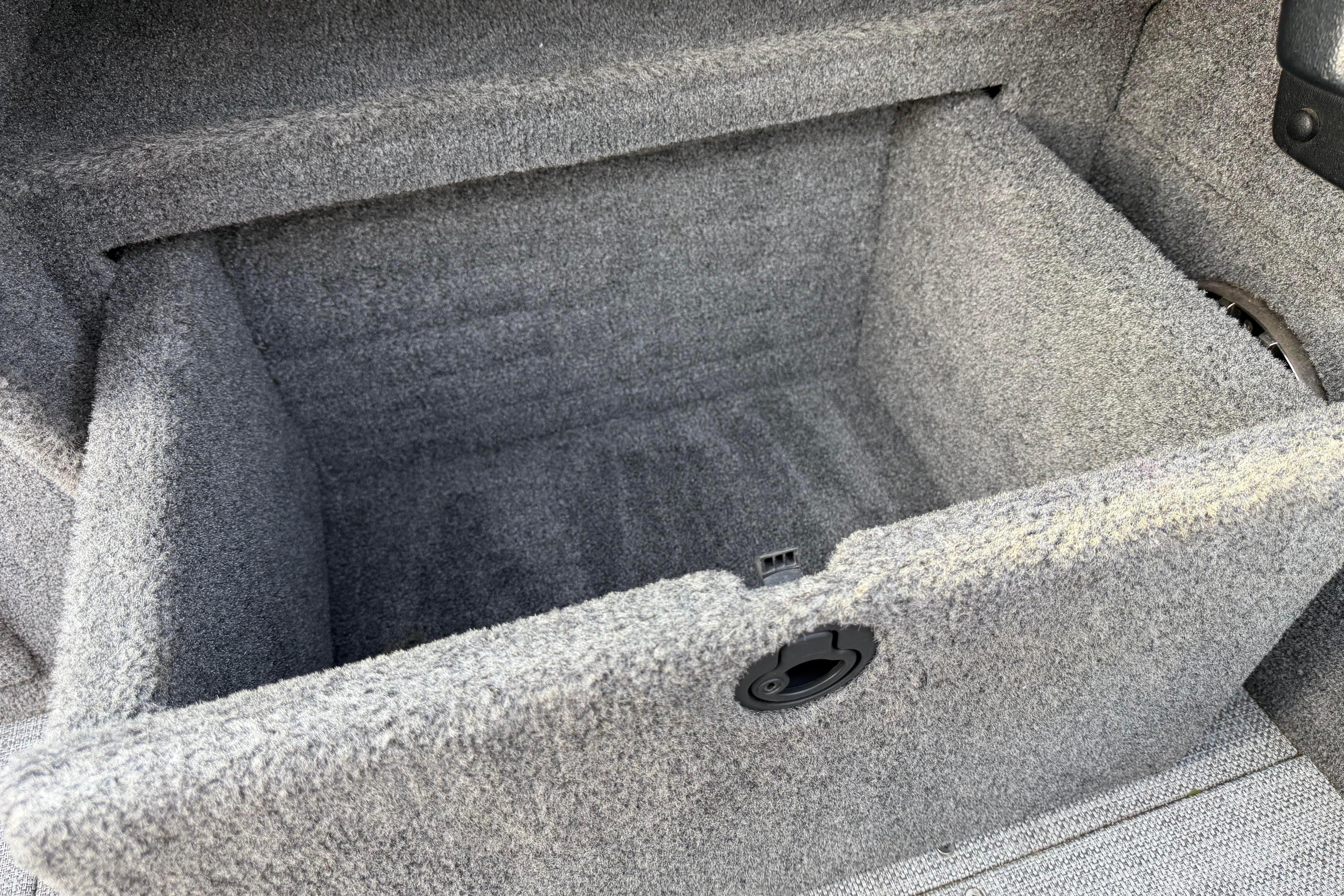 2019 Alumacraft Trophy 205 boat storage compartment with gray carpet interior.