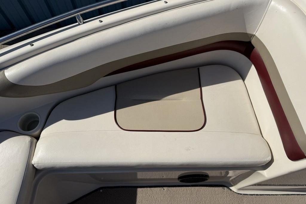 1999 Glastron GT 225 boat interior seating with beige and maroon upholstery.