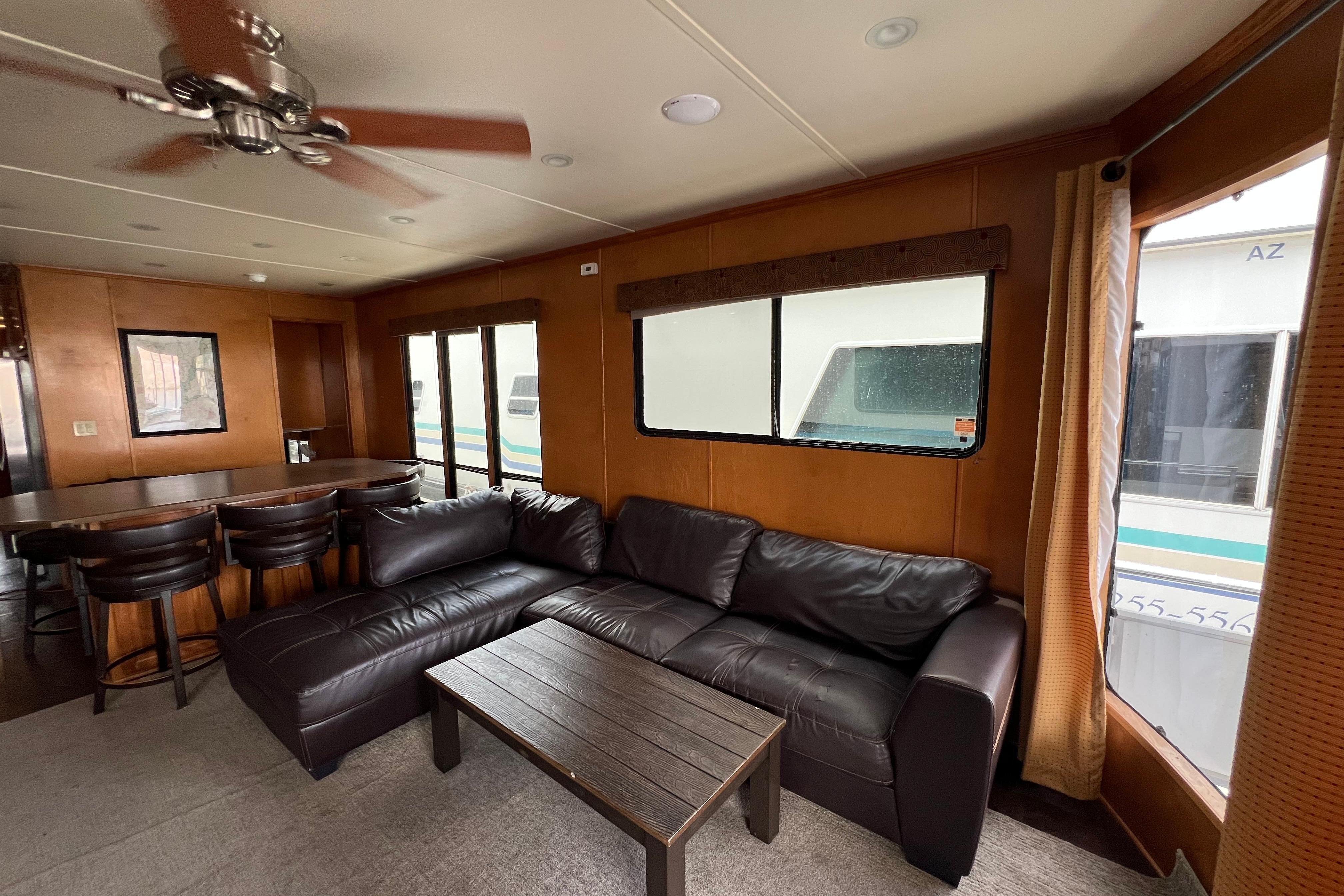 Luxurious interior of 2013 Destination Yacht Lotta Yachta with leather sofa and dining area.