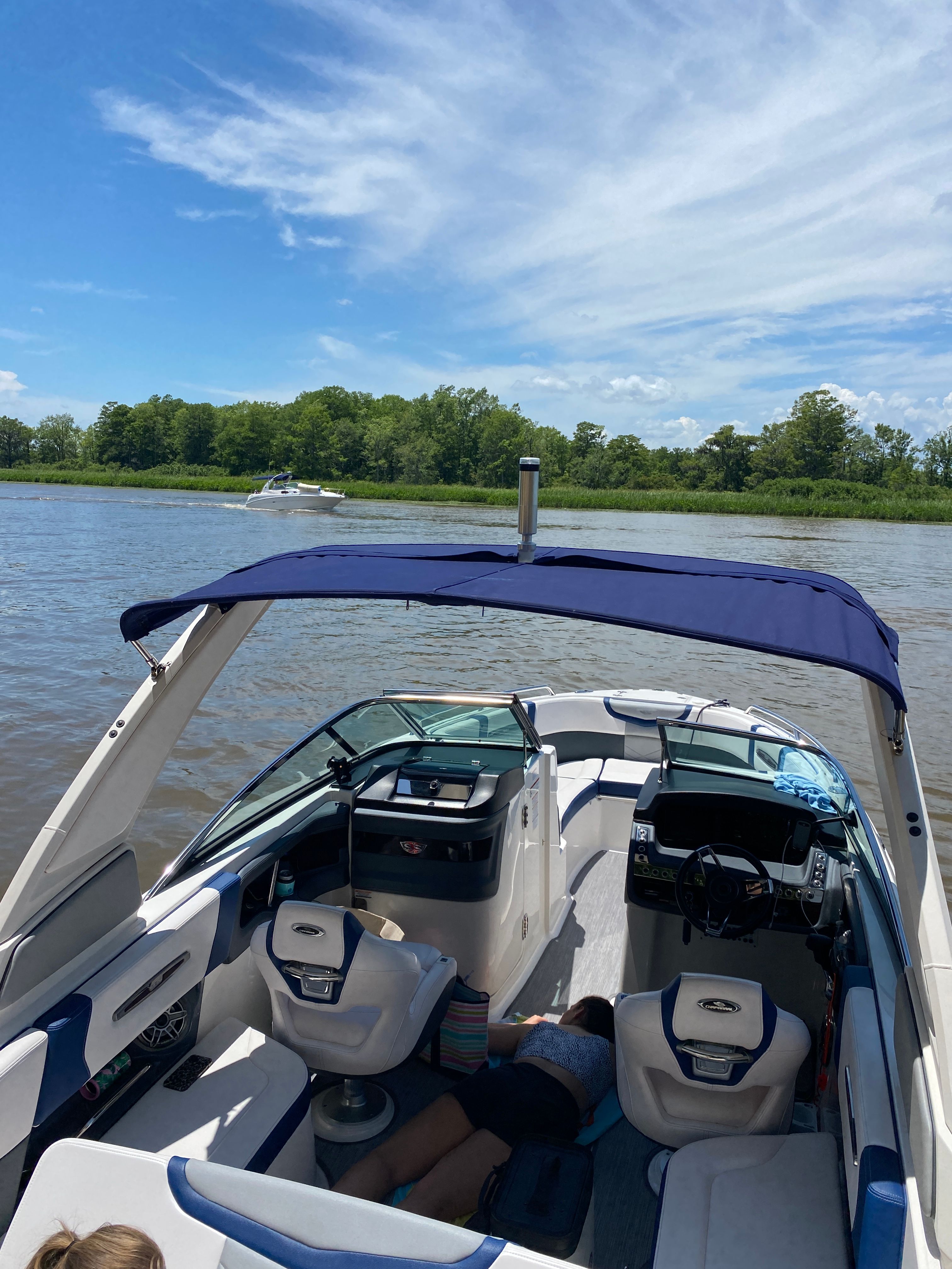 Chaparral 256 SSX 2020 on a calm river under sunny skies.
