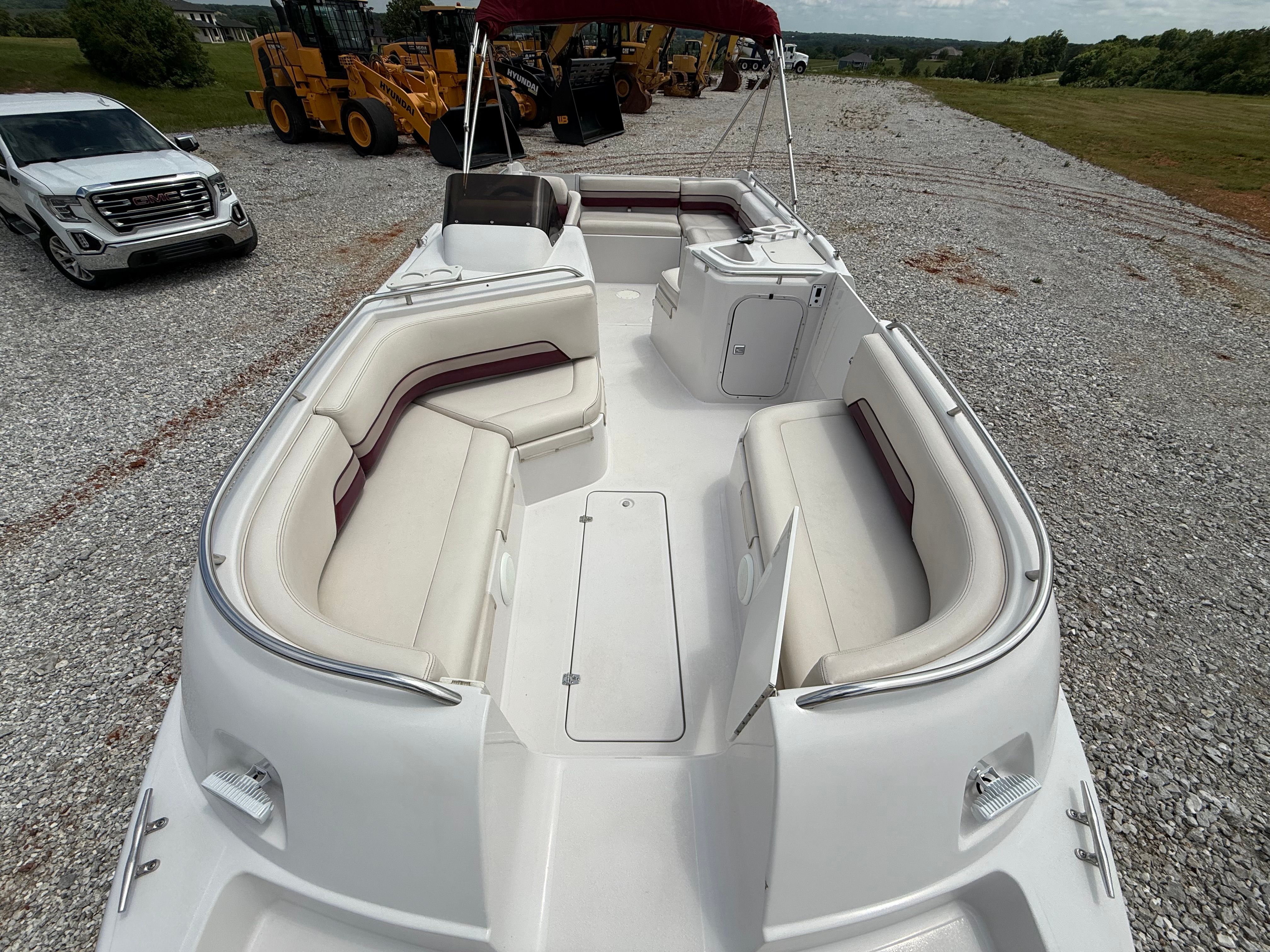 The image shows the spacious deck of a Chaparral Sunesta 220 boat with white seating.