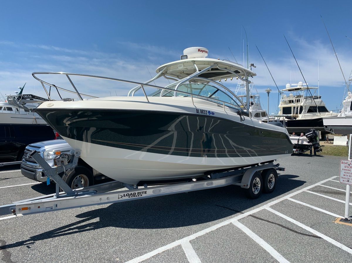 A 2023 Hydra-Sports Vector-VX boat on a trailer at a marina.