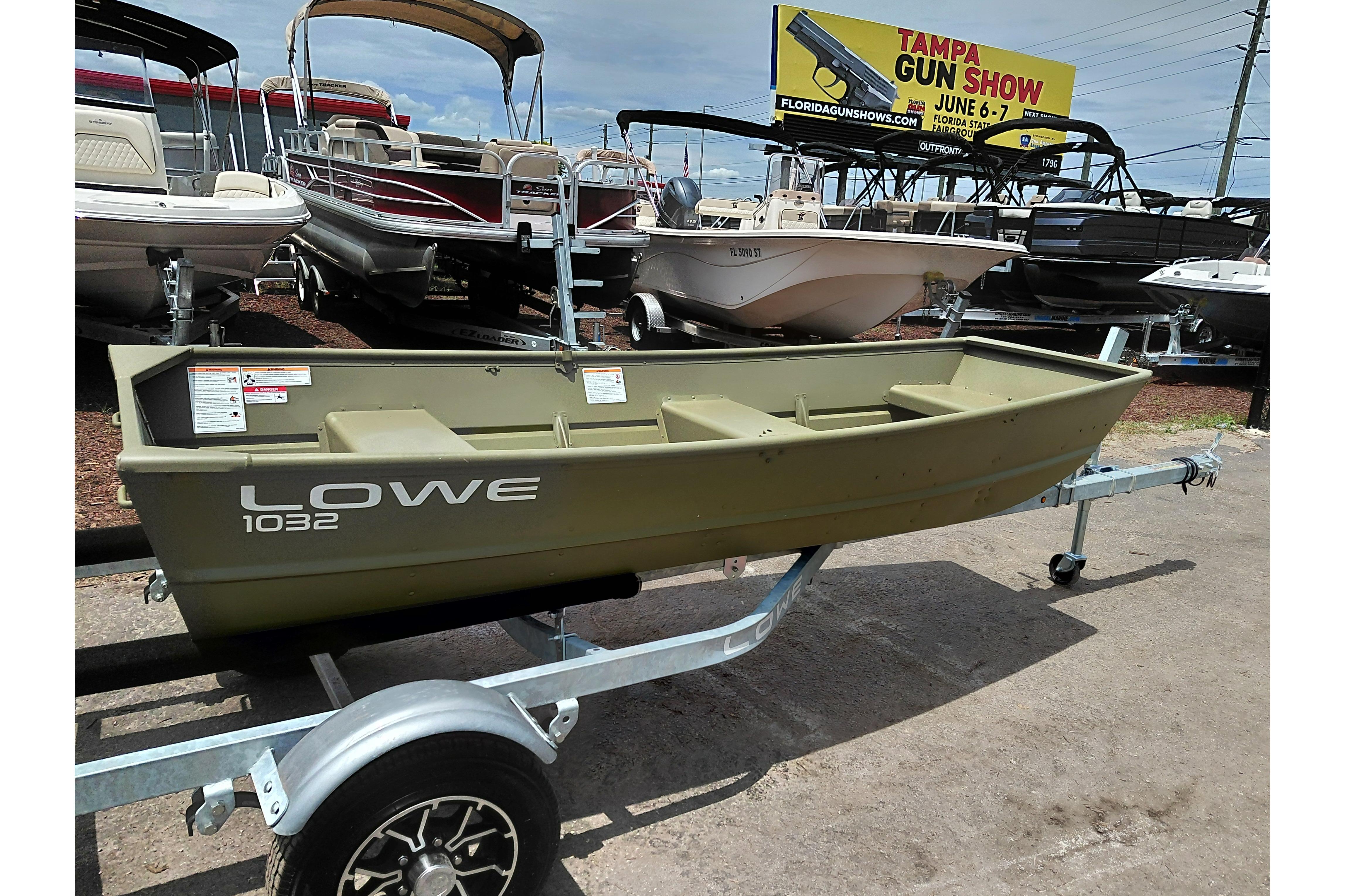 2026 Lowe L1032 Jon boat on trailer, displayed at dealership with other boats.