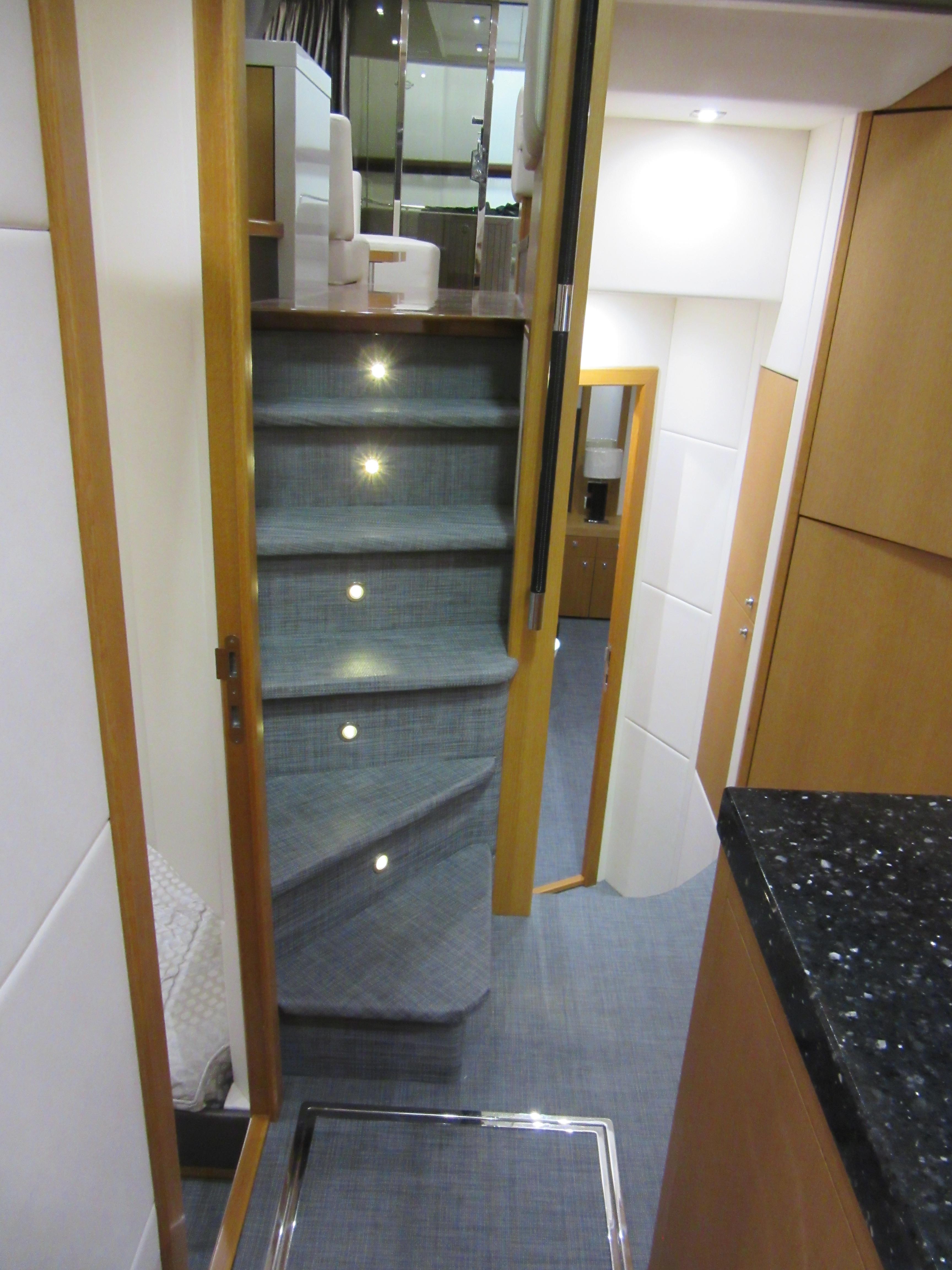 Interior staircase of 2014 Sunseeker Manhattan 53 yacht, featuring modern design and ambient lighting.
