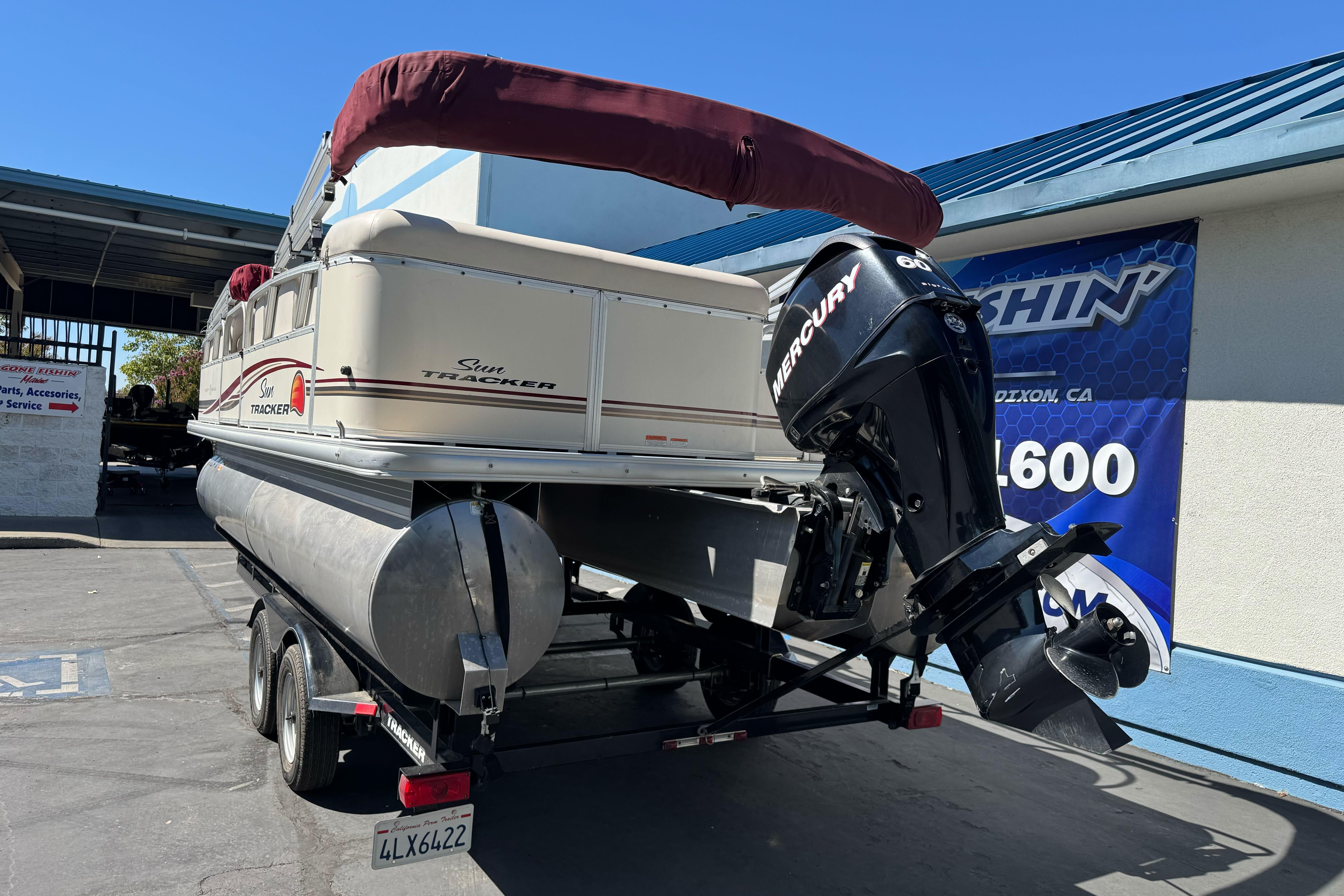 2011 Sun Tracker Party Barge 21 pontoon boat on trailer with Mercury outboard motor.