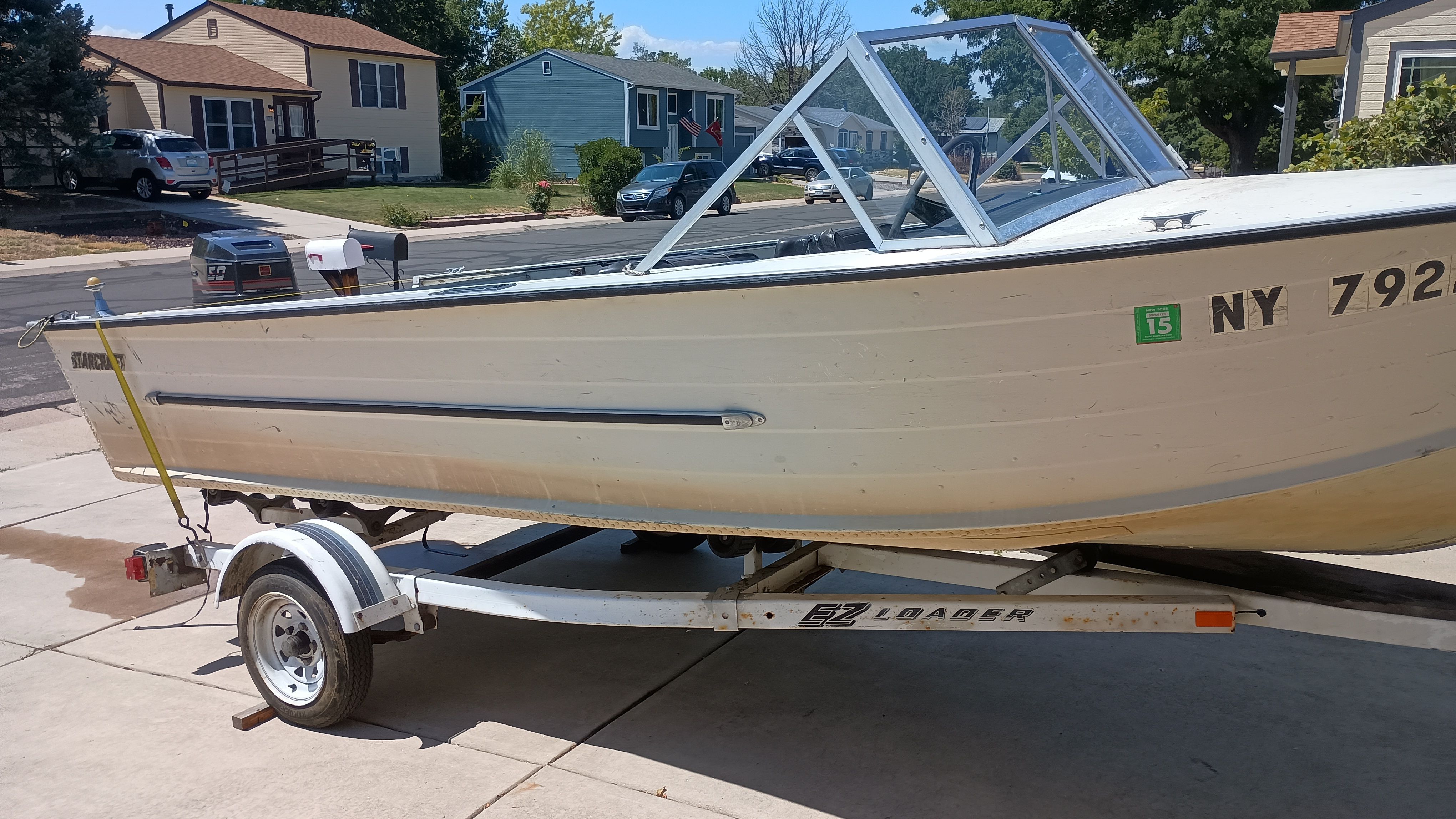 1970 Starcraft Jupiter V boat on trailer in residential area.