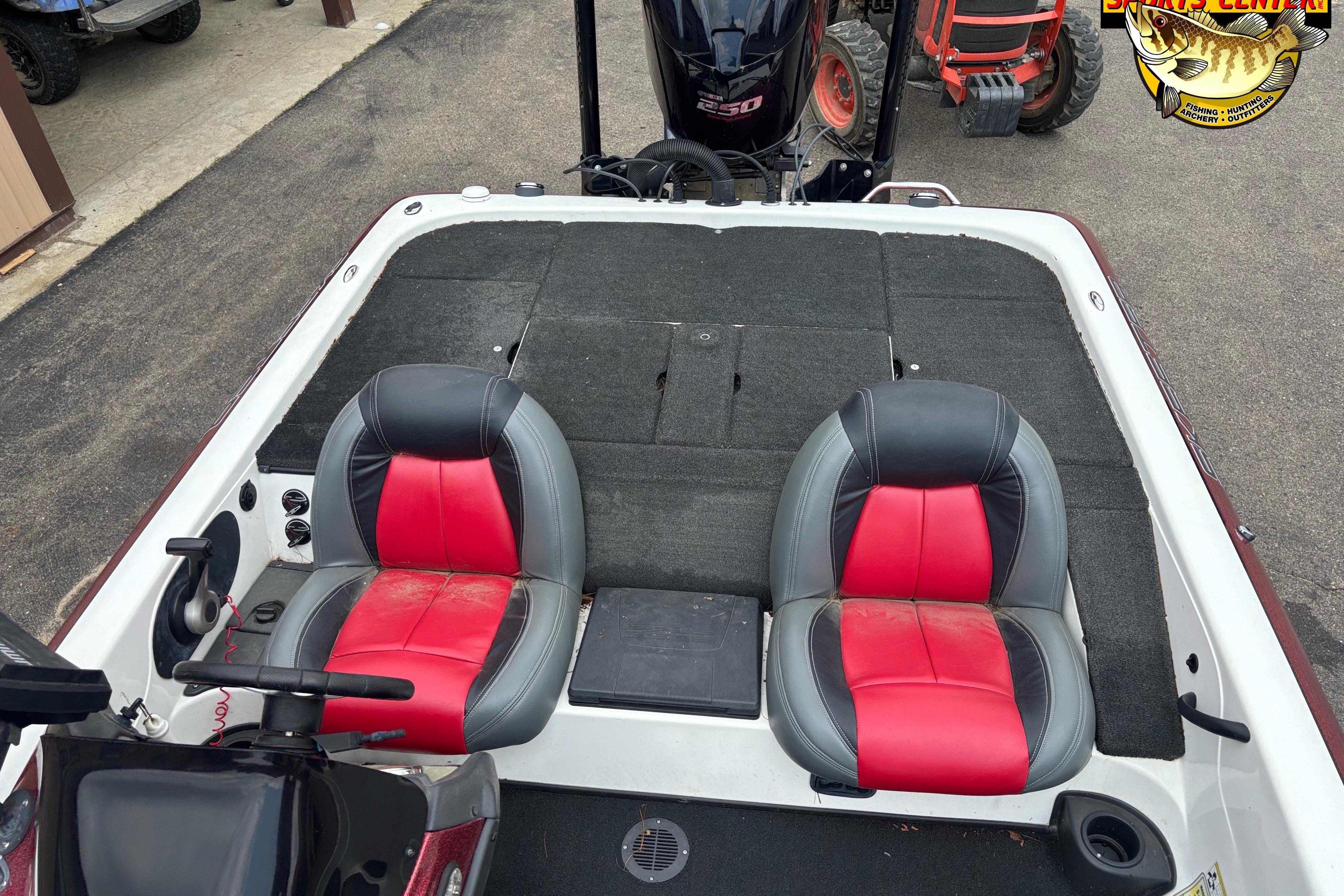 2013 Skeeter ZX20 boat interior with red and black seats, carpeted deck, and steering console.