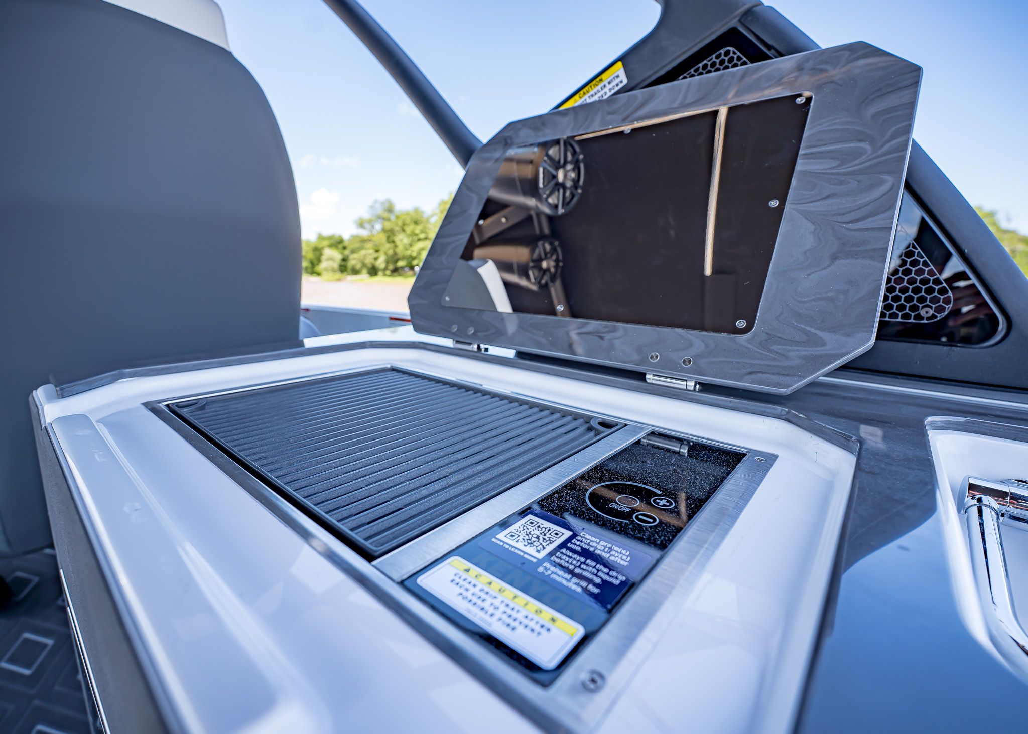 2025 Paradigm 266 SL SURF boat with integrated grill and control panel.