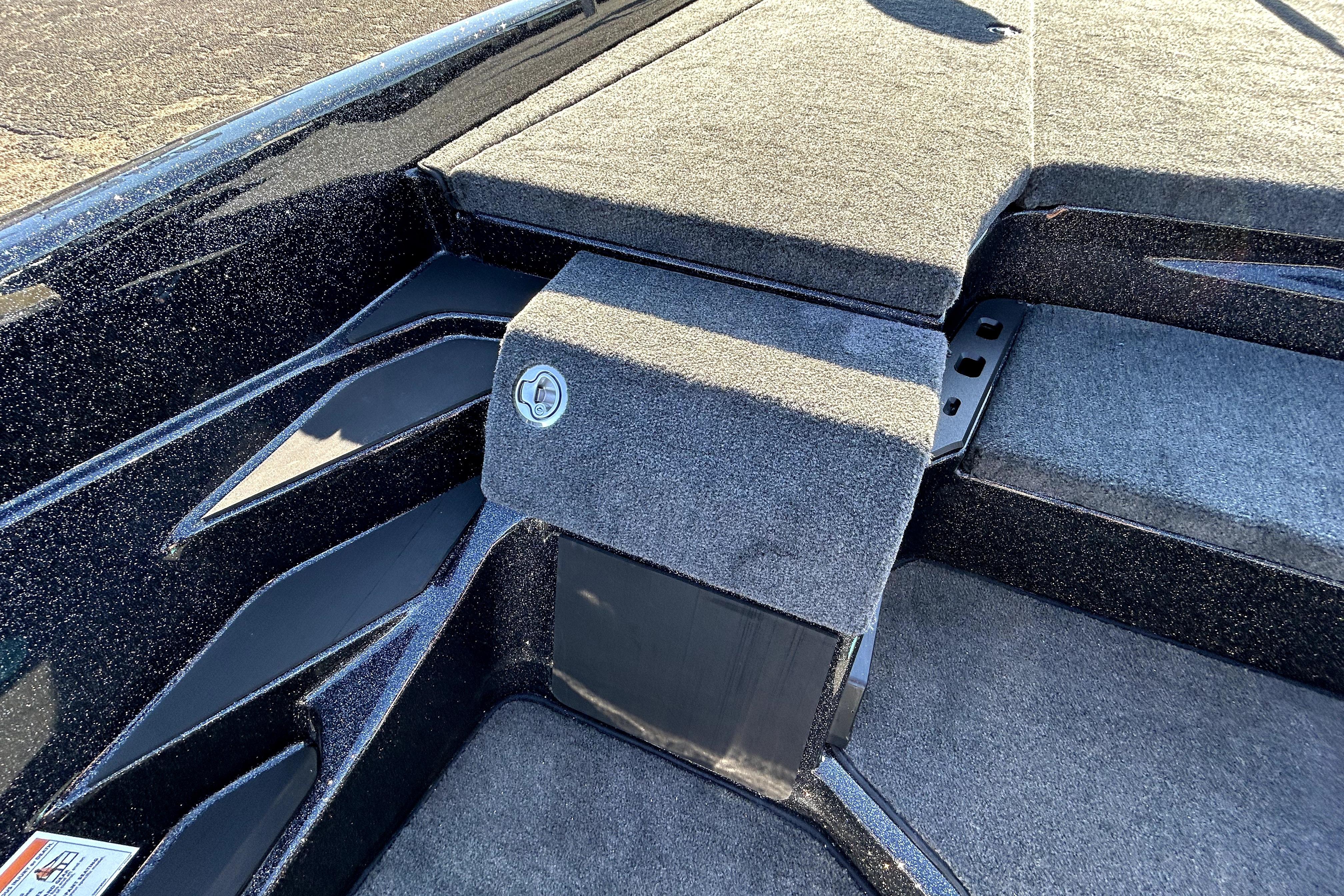 2026 Skeeter ZXE21 boat interior with carpeted deck and storage compartment.