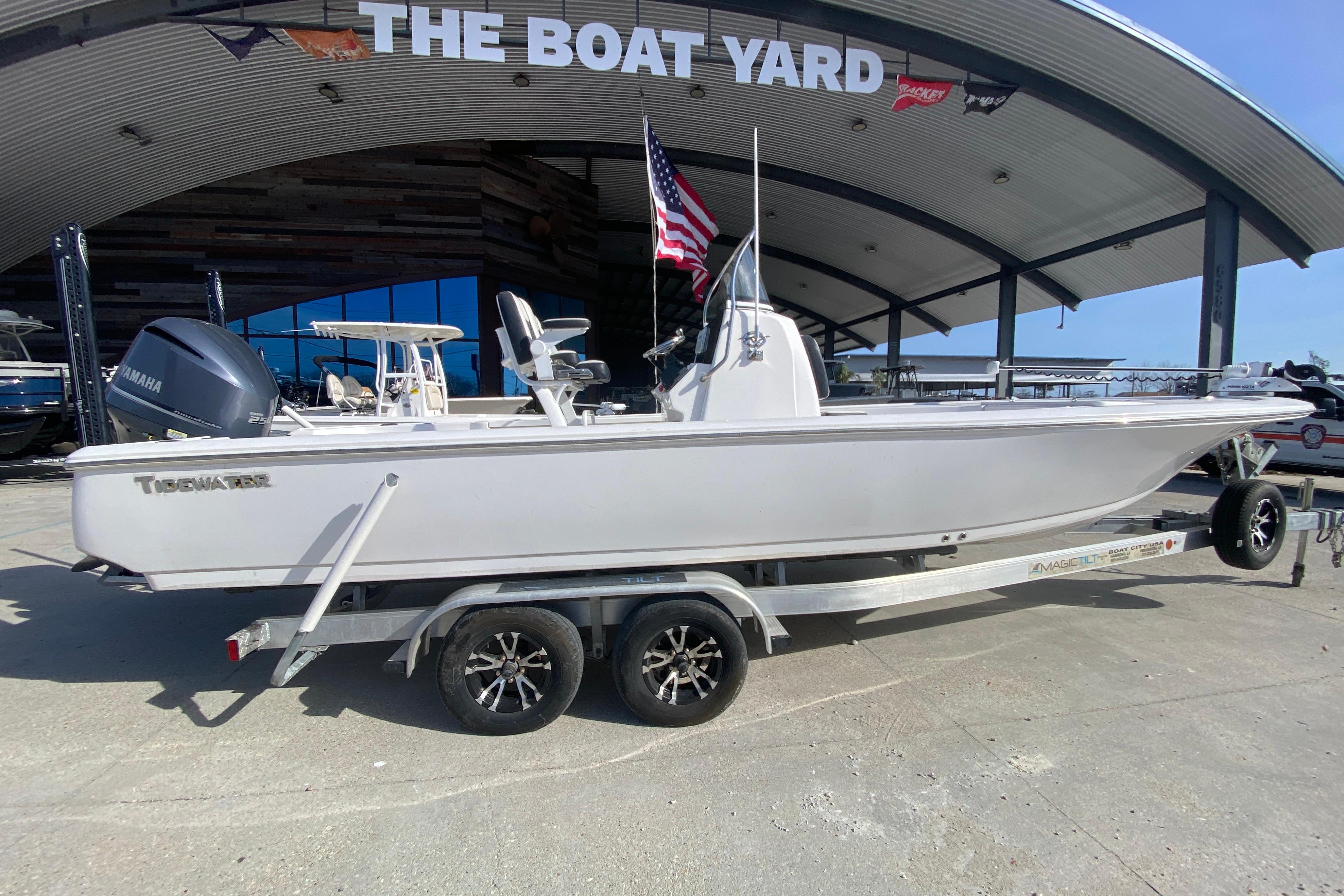 2023 Tidewater 2410 Bay Max boat on trailer at dealership.