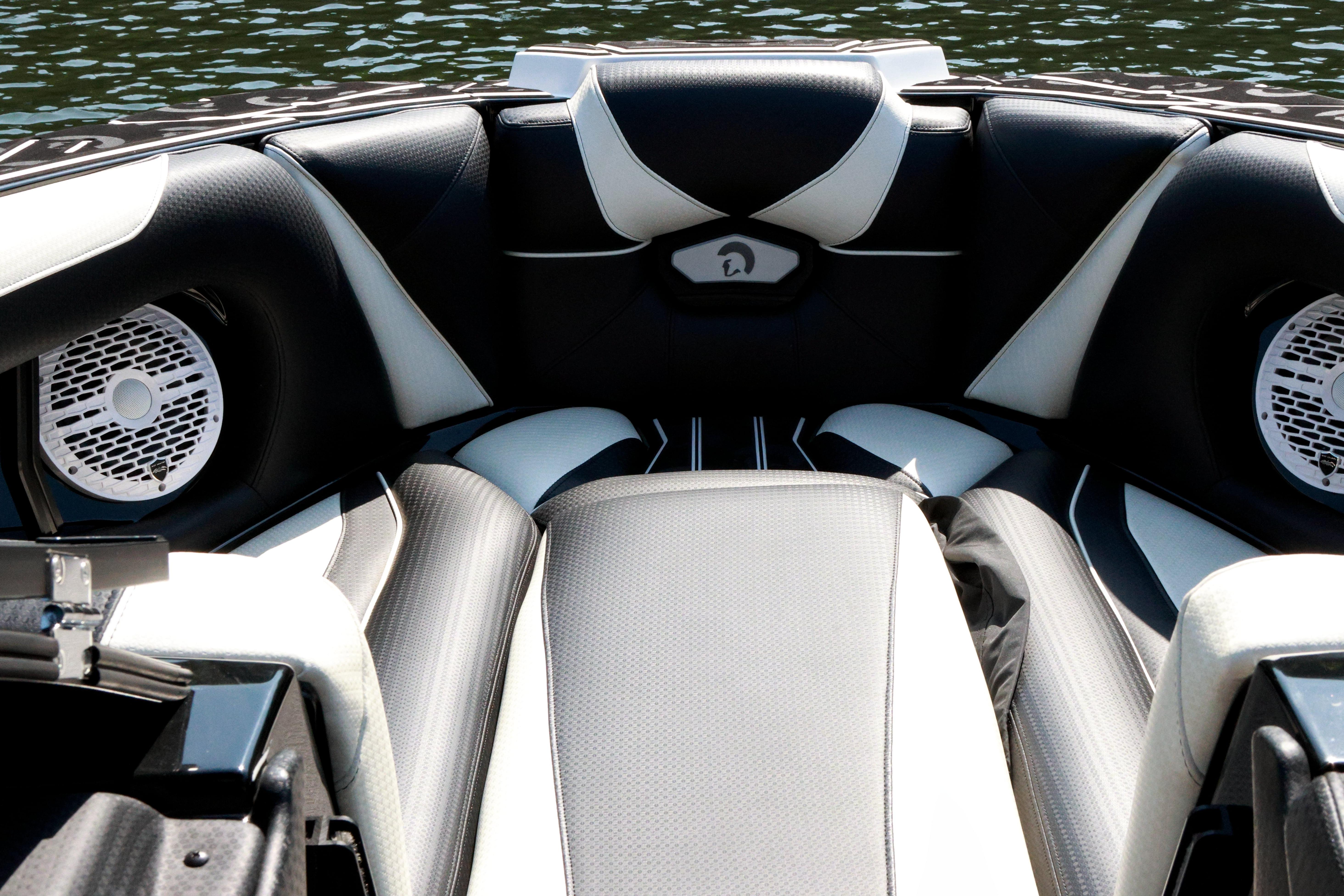 Interior of 2022 Centurion Ri265 boat with sleek black and white seating design.