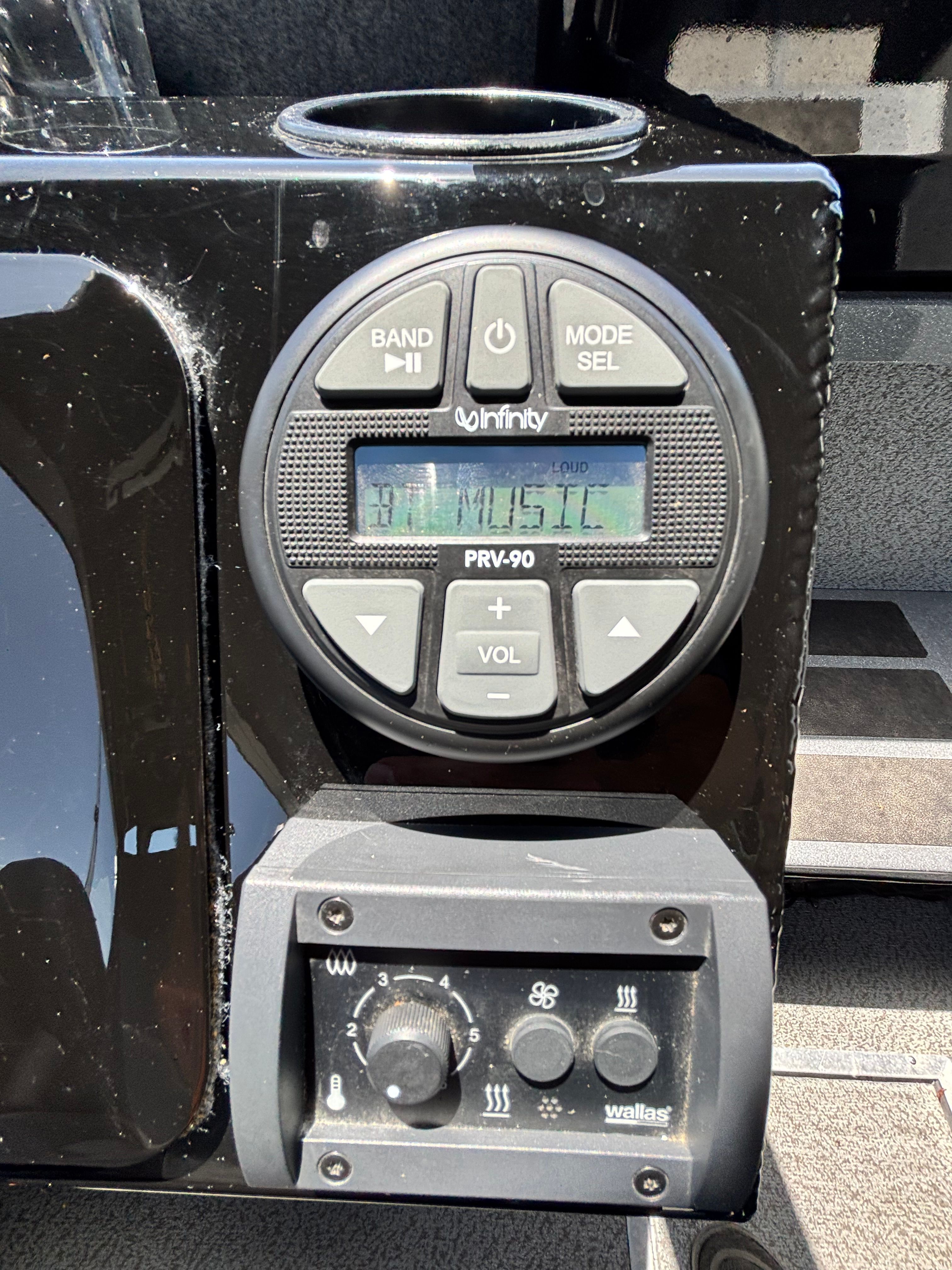 Close-up of a boat audio system with controls and display.