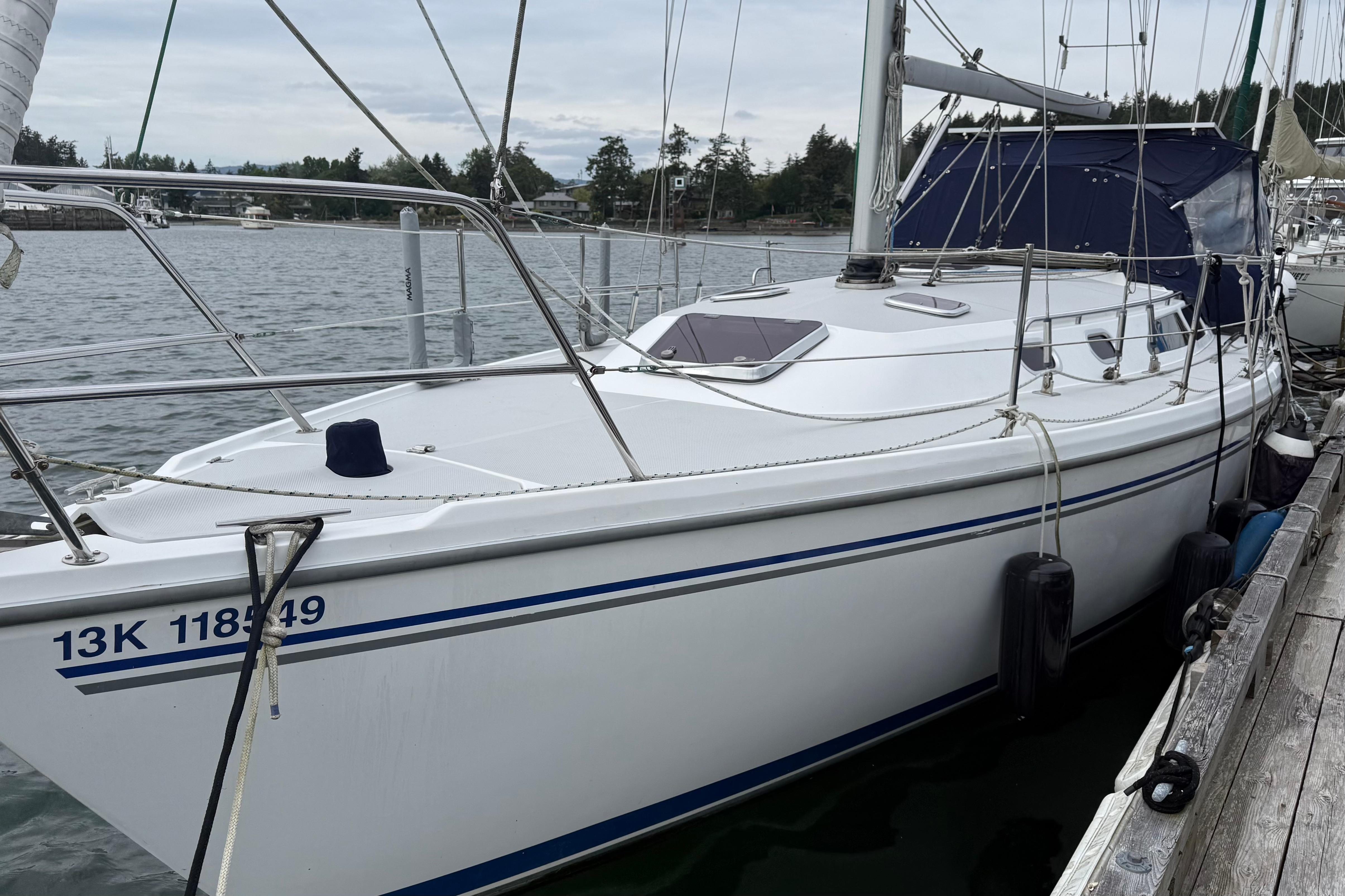 2005 Catalina 36 MkII sailboat docked in a serene marina setting.