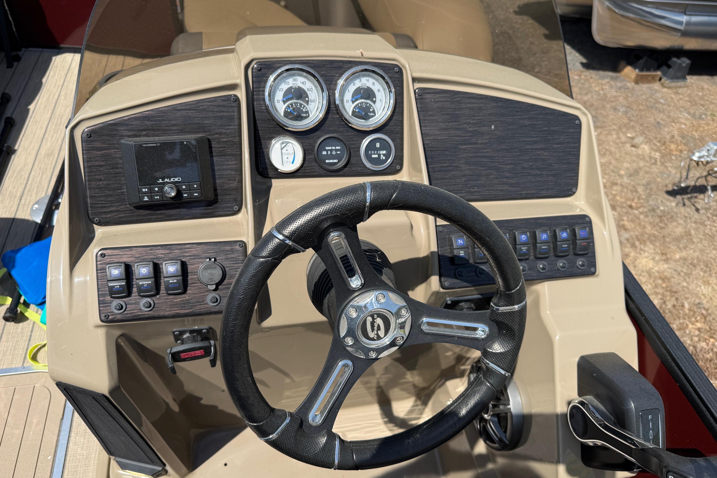 2024 Sylvan X1 CLZ DH boat dashboard with steering wheel and control panel.