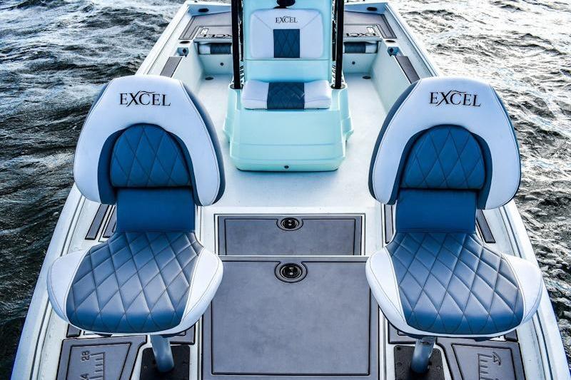 2026 Excel 230 Bay Pro Elite boat with stylish blue and white seating on water.