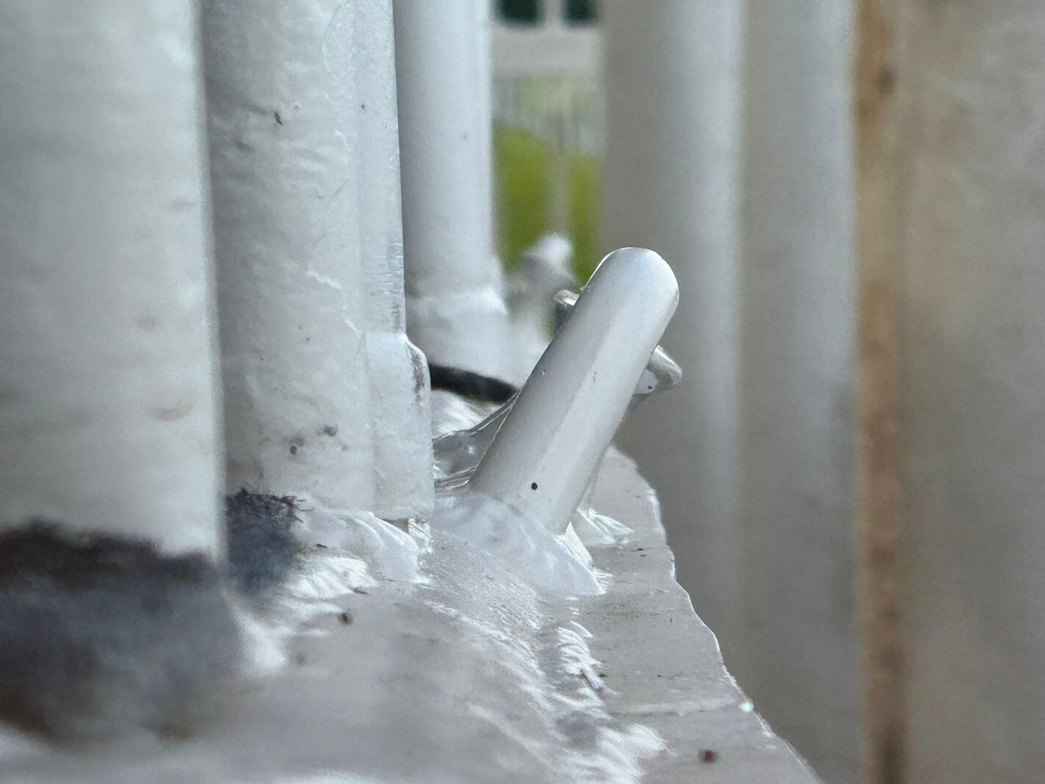 Close-up of white metal pipes with welding seams.