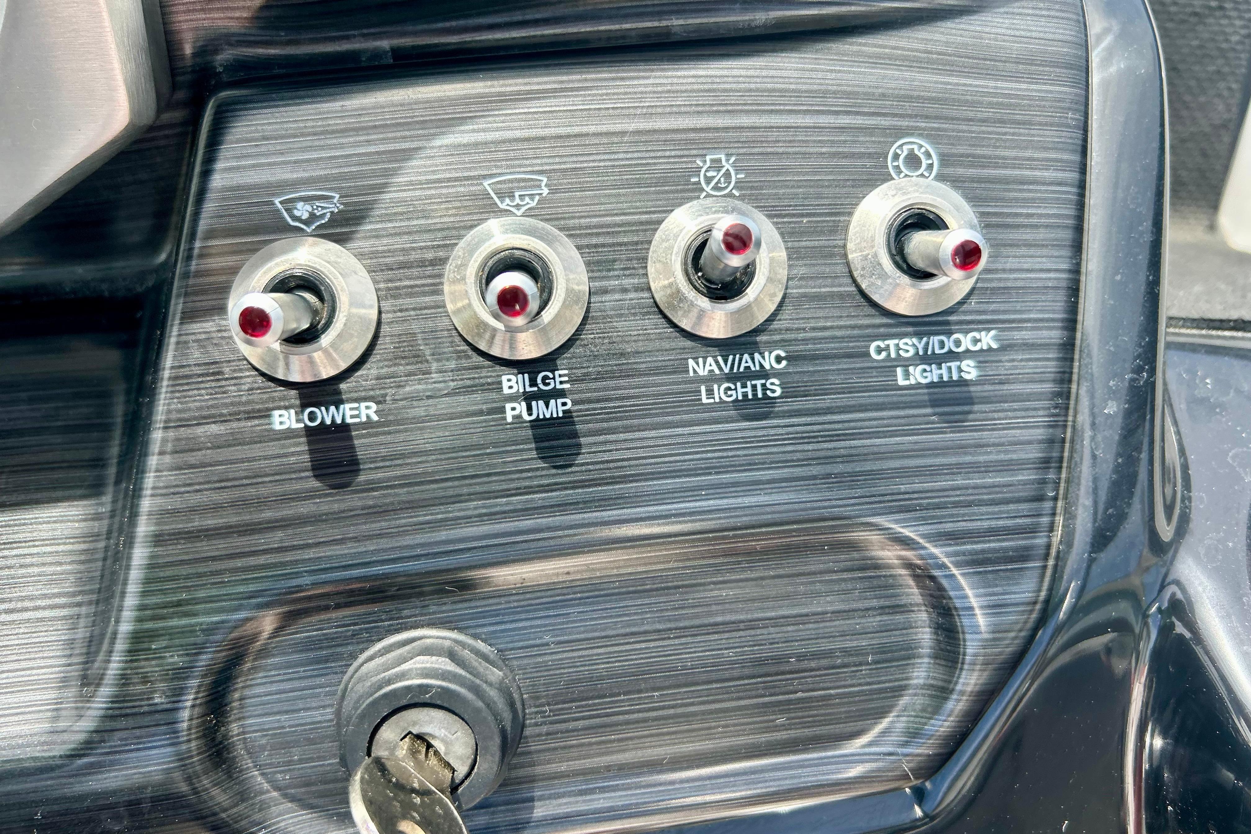 Control panel of a 2021 Scarab 195 ID boat with switches for blower, bilge pump, and lights.