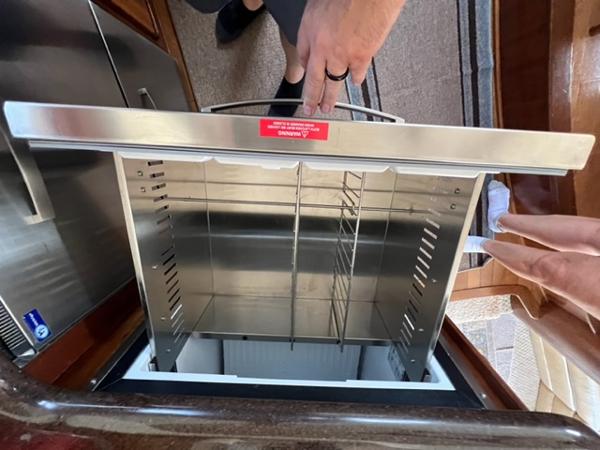 Open stainless steel drawer in a 2009 Ovation 52 yacht kitchen.