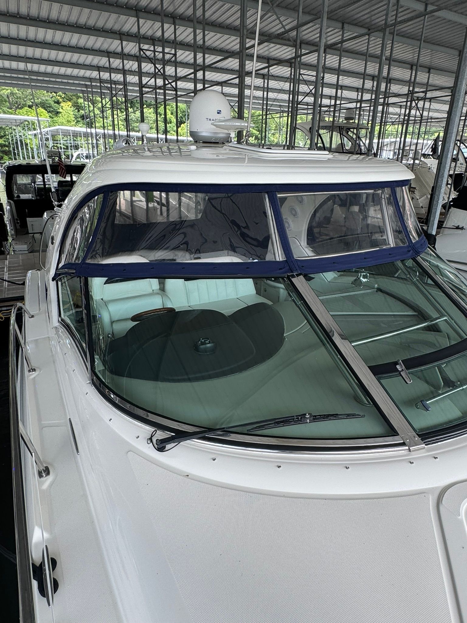 A 2007 Sea Ray 40 Sundancer in a covered dock.
