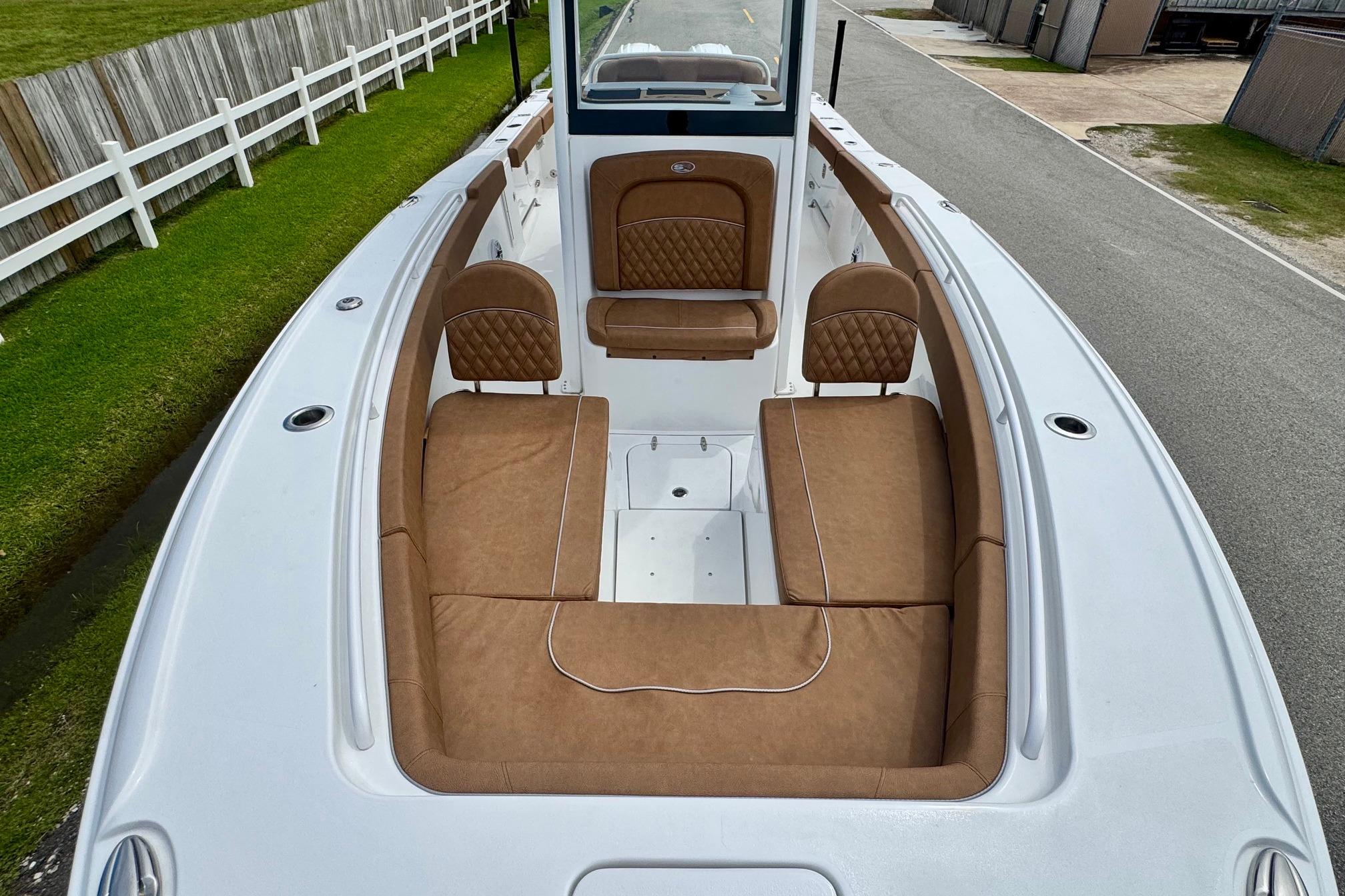 2026 Sea Hunt Ultra 275 SE boat with brown cushioned seating and white deck.