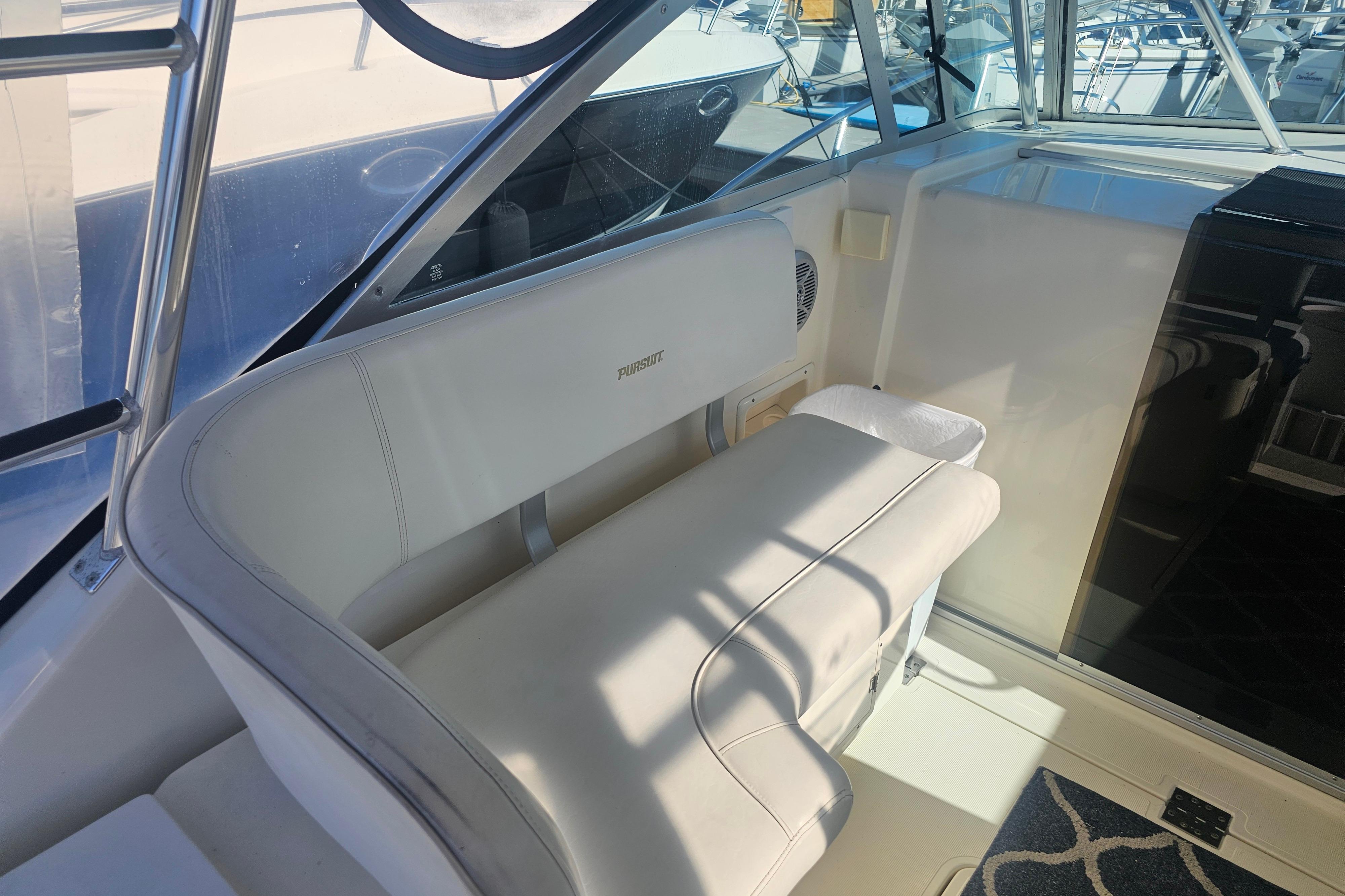 2001 Pursuit 3000 Express boat interior with white seating and helm area.