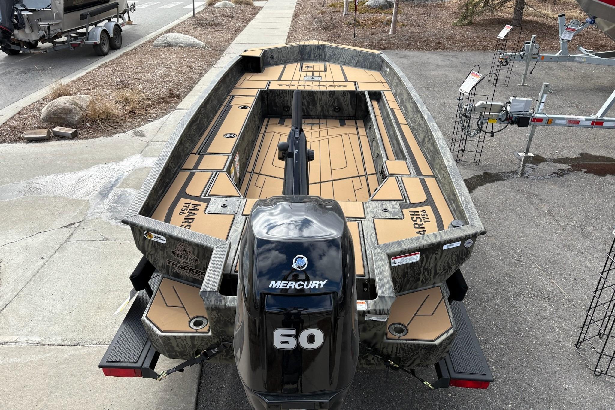2026 Tracker Grizzly 1756 T Marsh boat with Mercury 60 engine, parked outdoors.