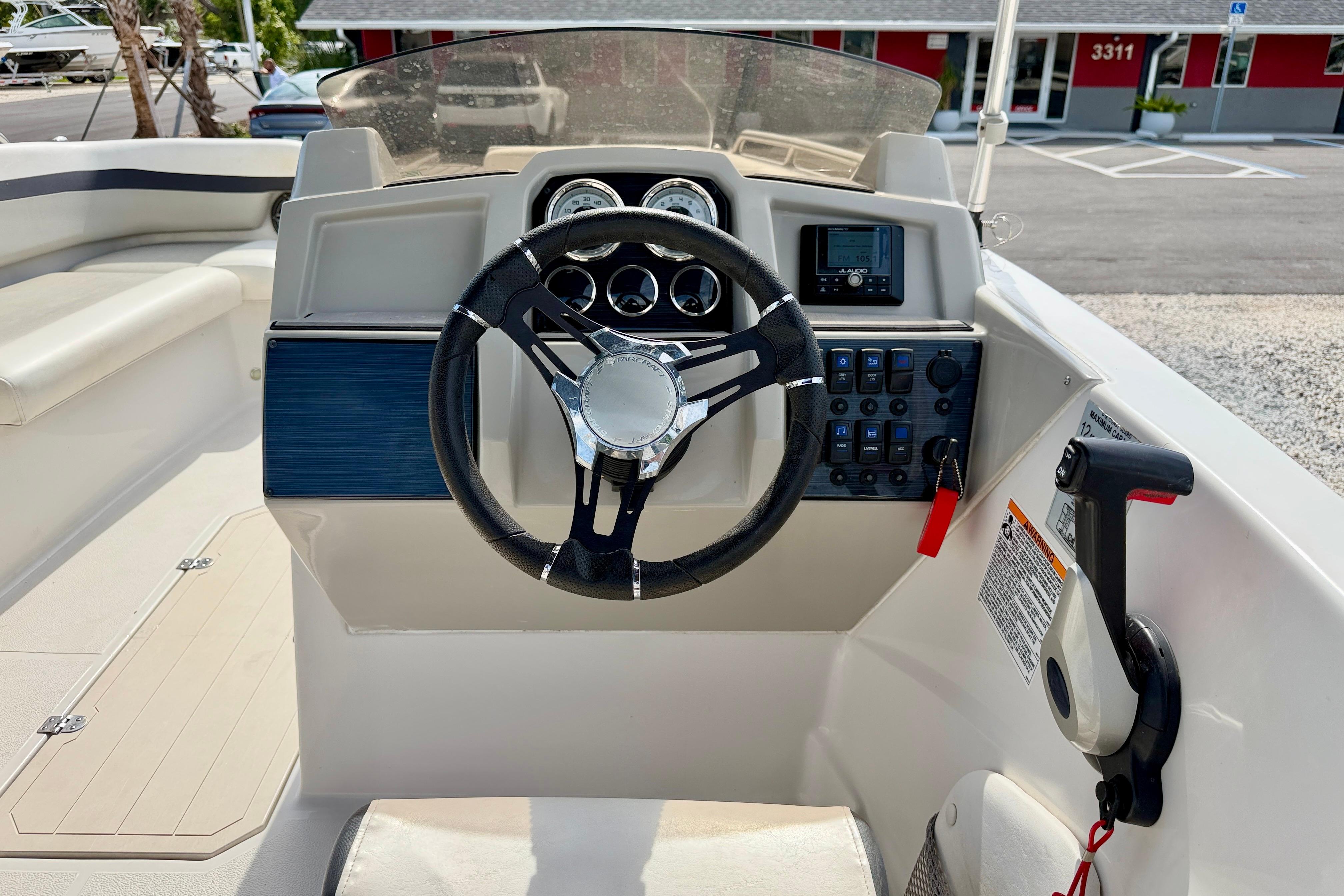 2021 Starcraft SVX 191 OB boat dashboard with steering wheel and control panel.