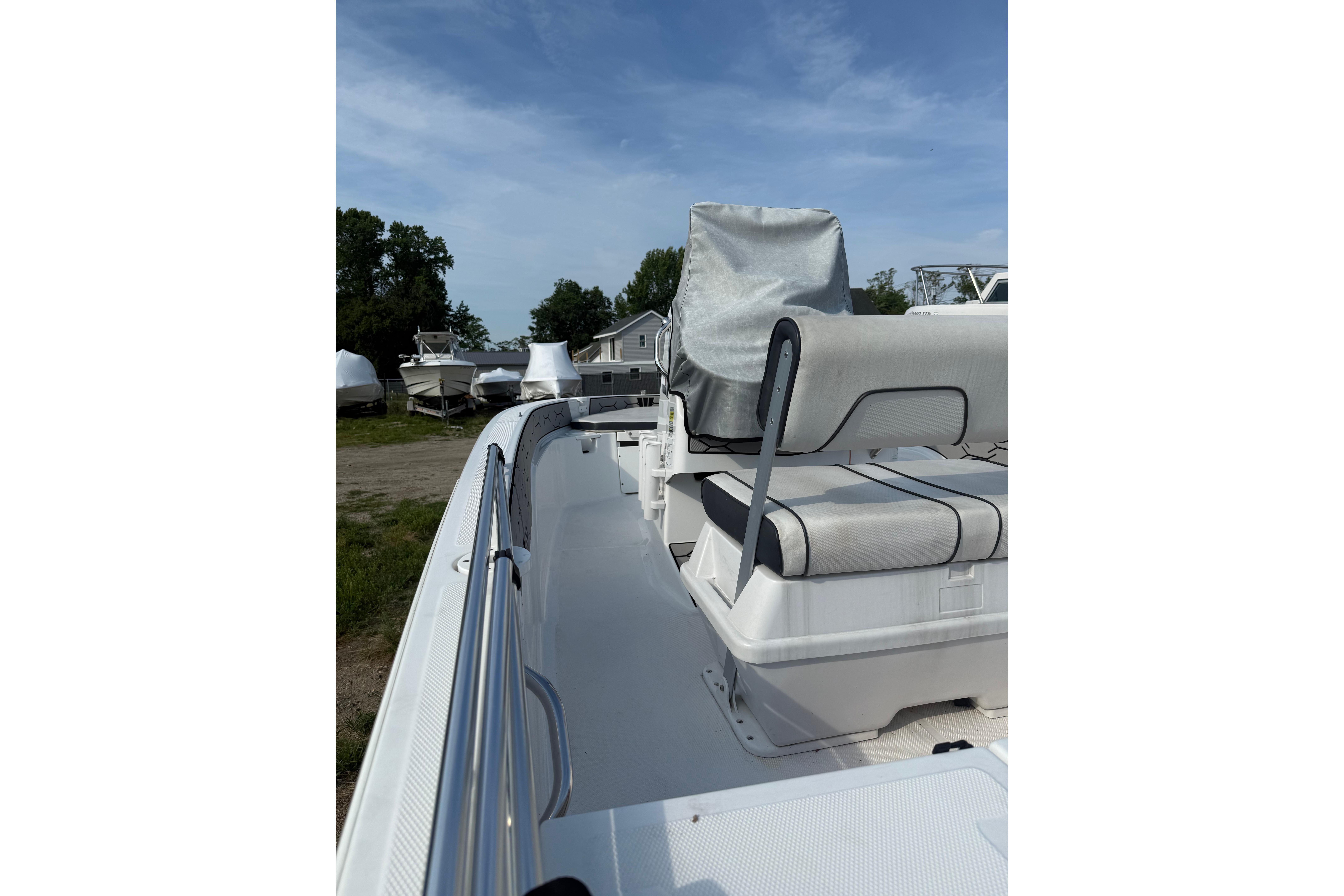 2020 Wellcraft 162 Fisherman boat interior with seating and railing under a clear sky.