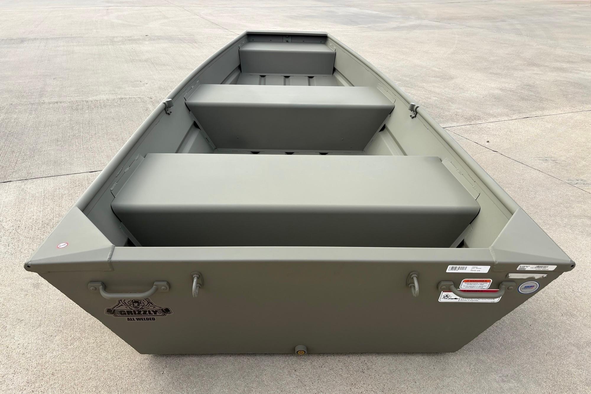 2026 Tracker Grizzly 12 Jon boat, olive green, on concrete surface.