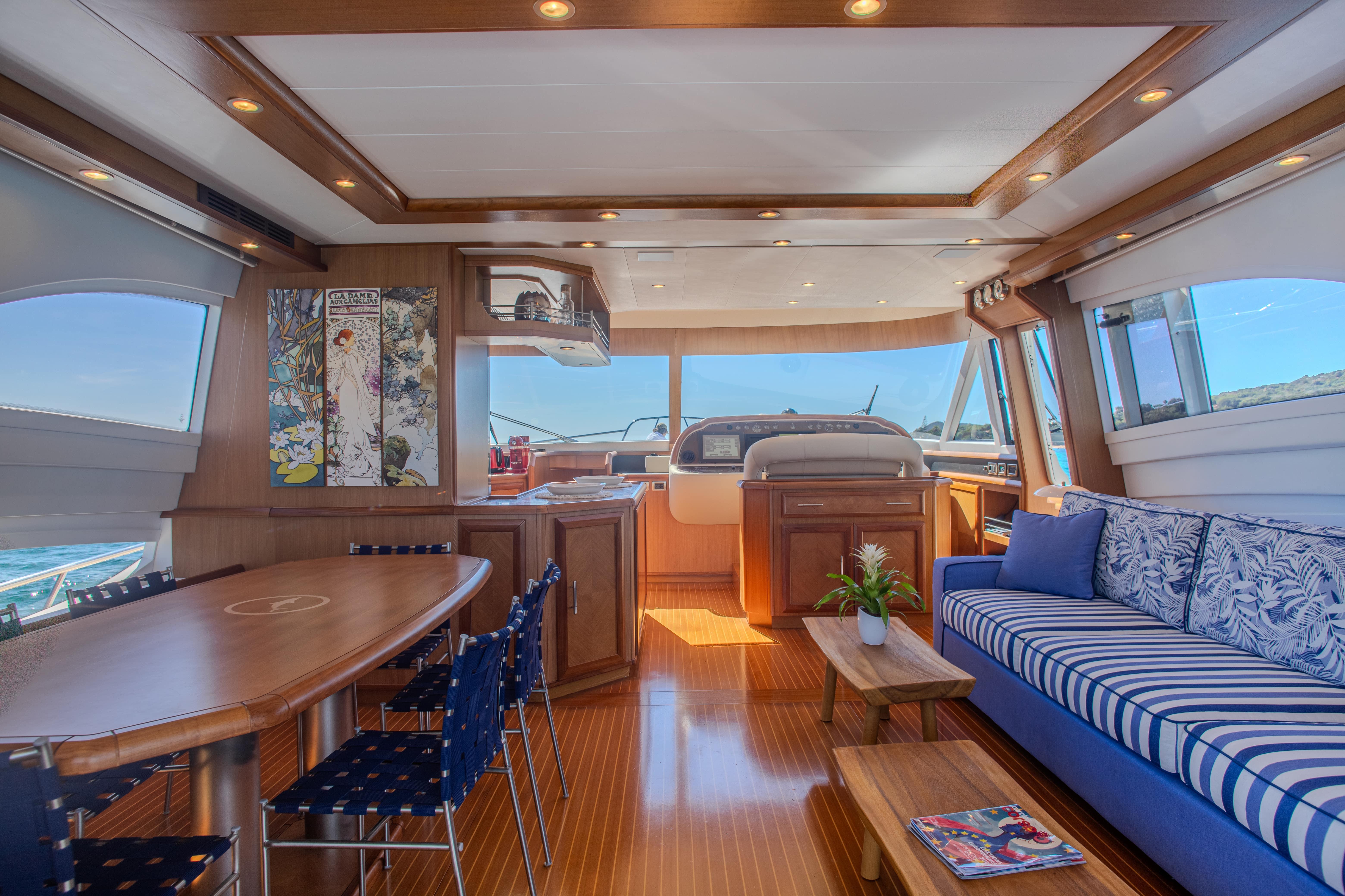 Luxurious interior of 2005 Mochi Craft 74' Dolphin yacht with elegant wood finishes and plush seating.