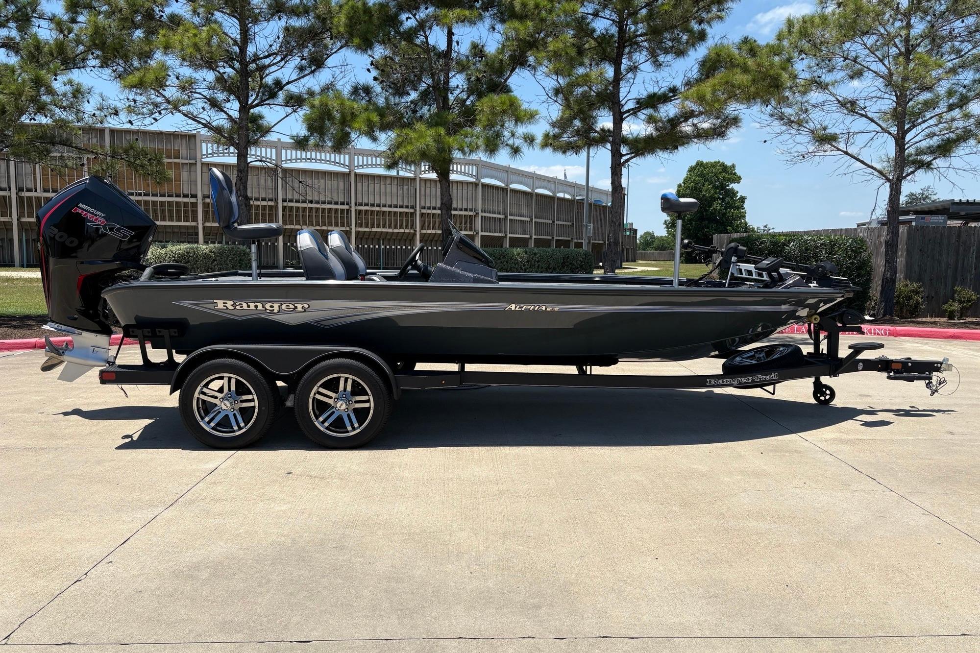 2025 Ranger ALPHA 208 boat on trailer, parked outdoors, under clear blue sky.