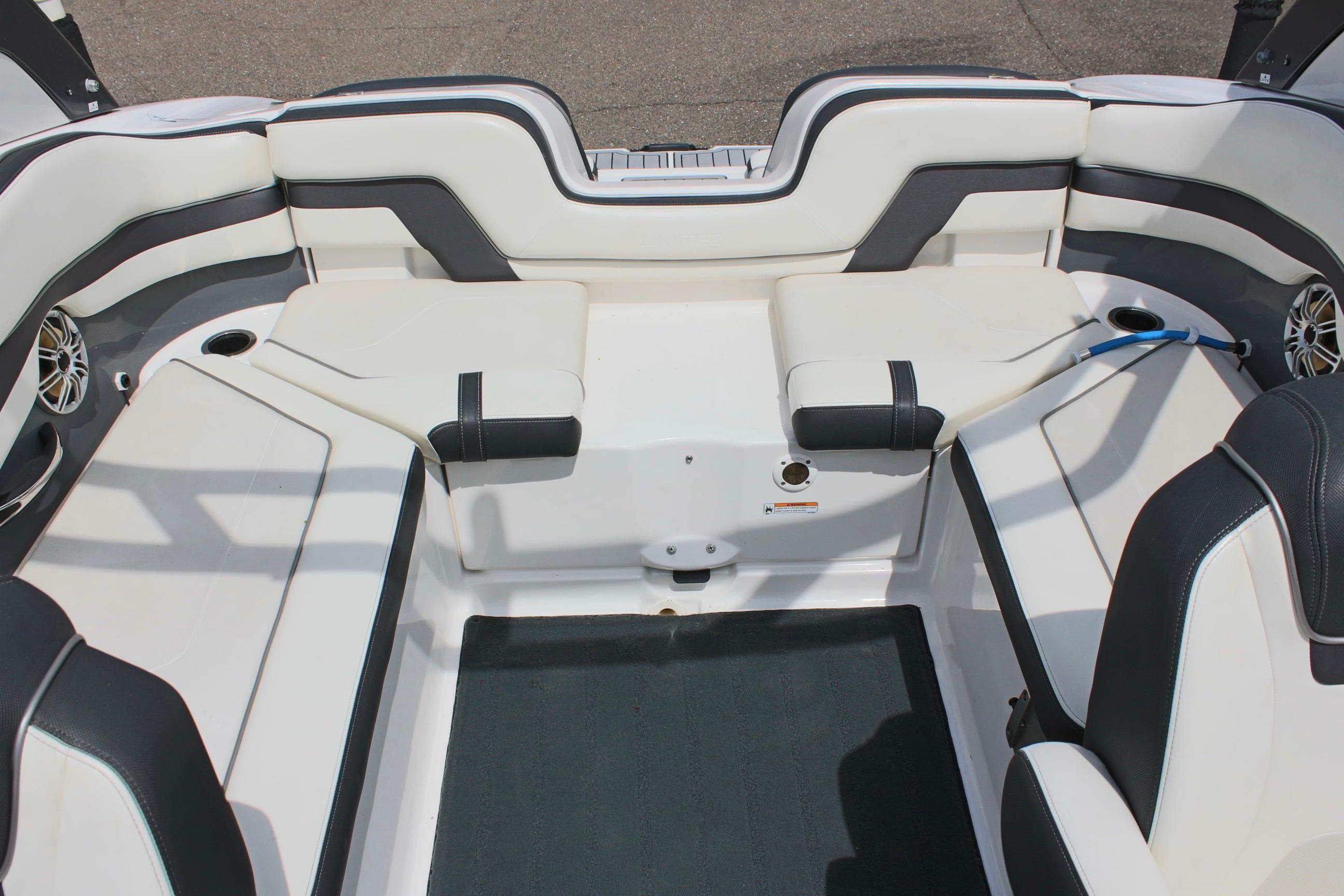Interior seating of a 2016 Yamaha Boats 242 Limited S, featuring white and black upholstery.