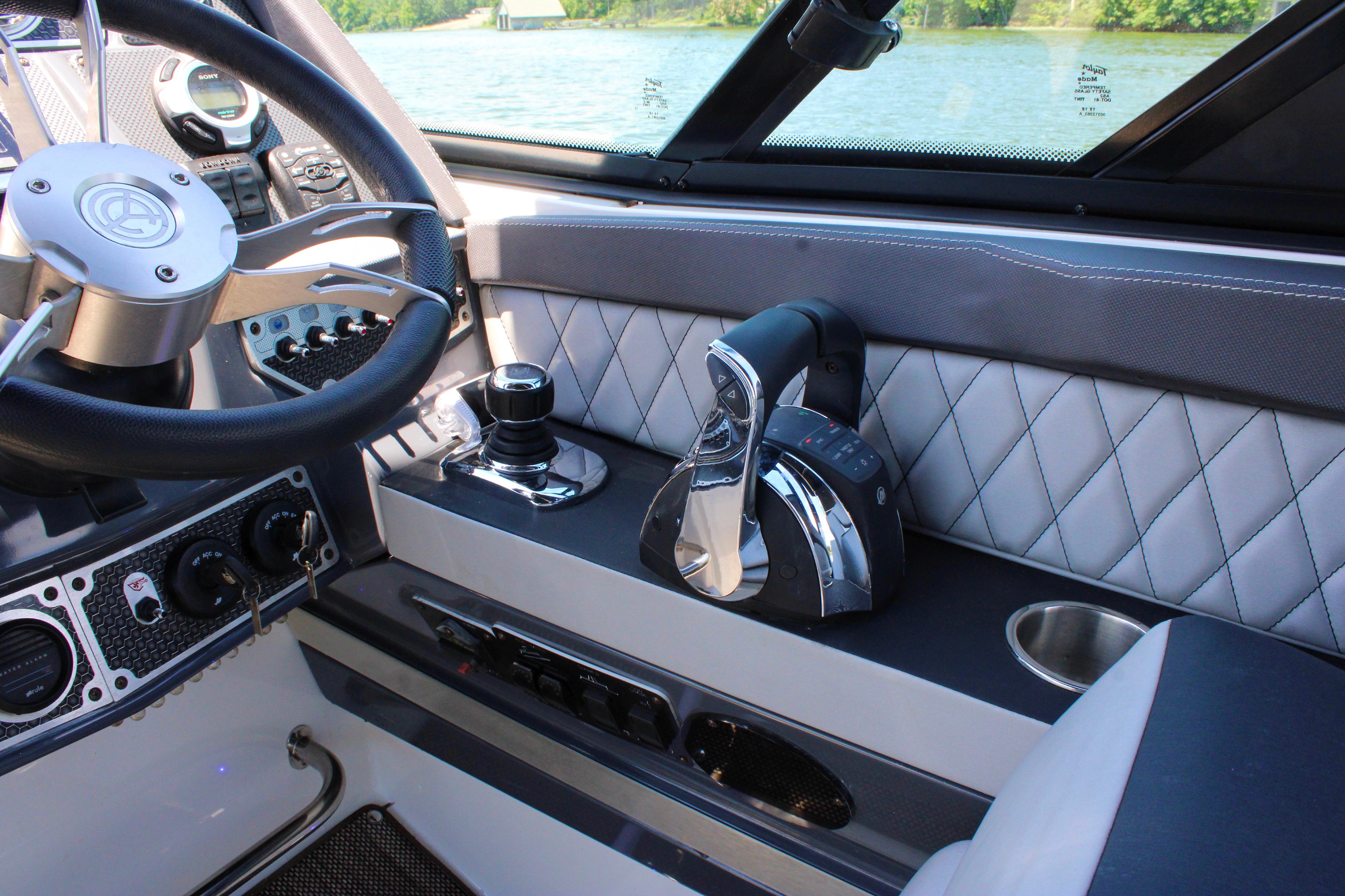 2017 Cruisers Yachts 338 Bow Rider helm with steering wheel and controls.