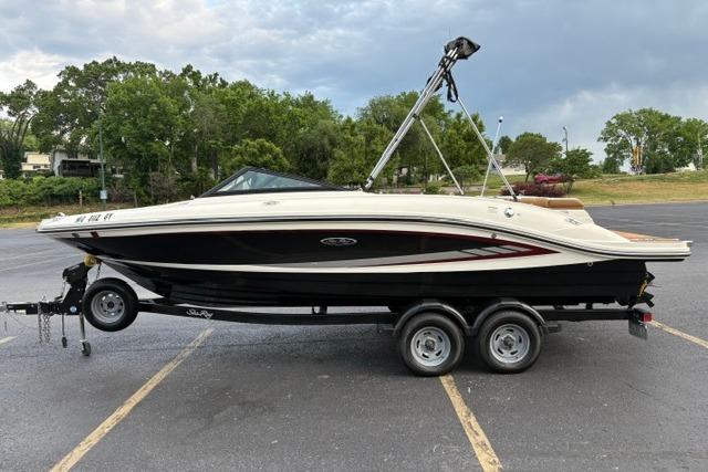 2017 Searay SPX210 boat on trailer in parking lot, side view.