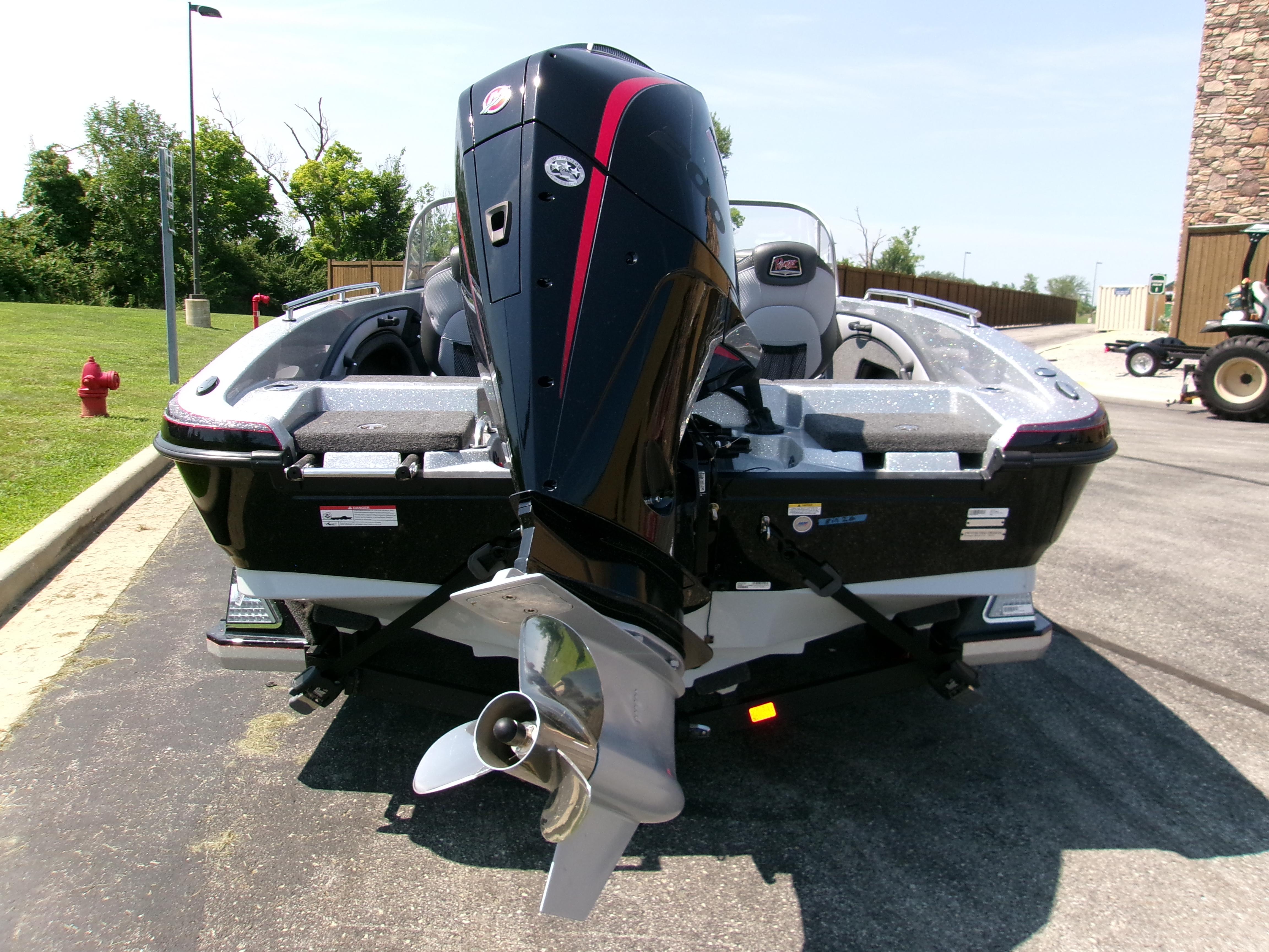 2025 Ranger 1880MS boat with powerful outboard motor, parked on pavement.