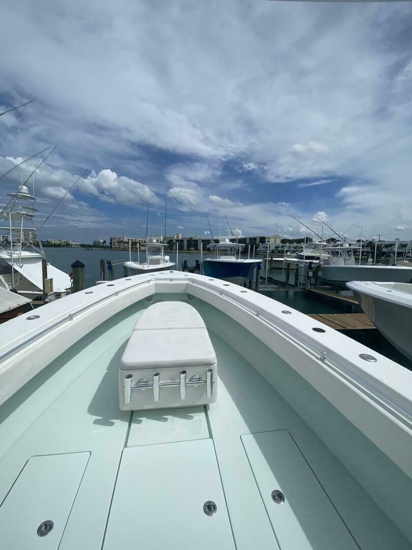 2012 Contender 39ST boat docked at marina under cloudy sky.