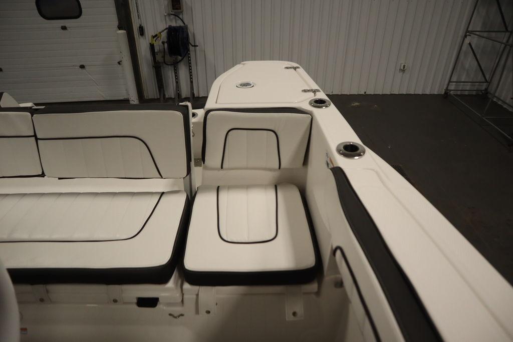 Interior seating of 2026 Yamaha Boats 255 FSH Sport E, featuring white upholstery with black accents.