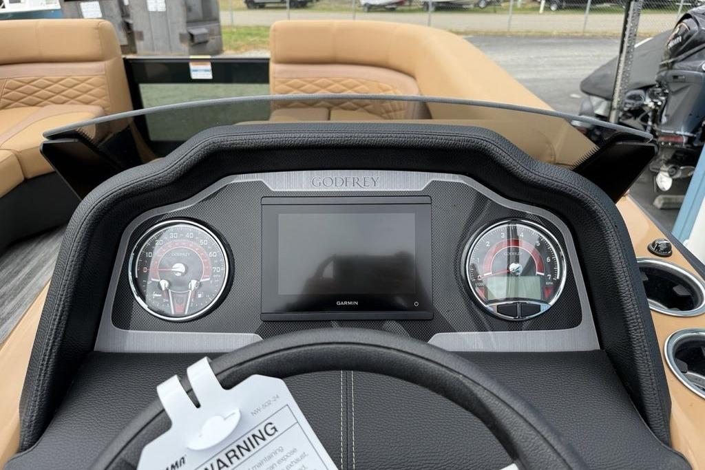 Dashboard of 2026 Godfrey Monaco 235 SFLC iMPACT boat with gauges and Garmin display.