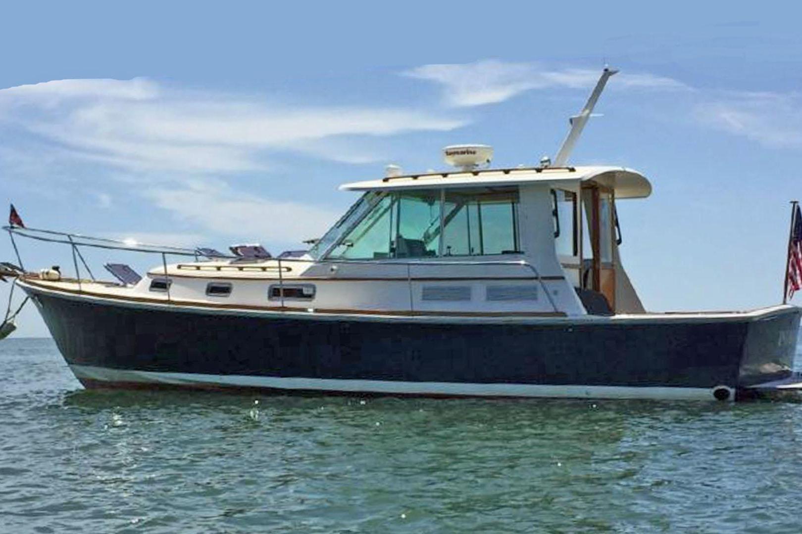 2004 Bruckmann Bluestar 38 boat on calm water under clear sky.