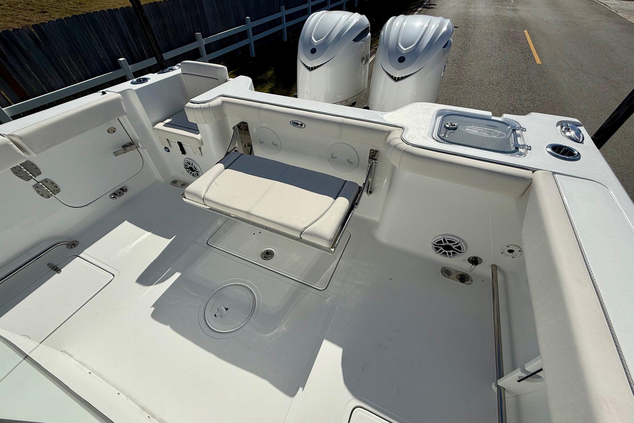 2026 Sea Hunt Gamefish 30 Coffin Box boat interior with seating and dual engines.