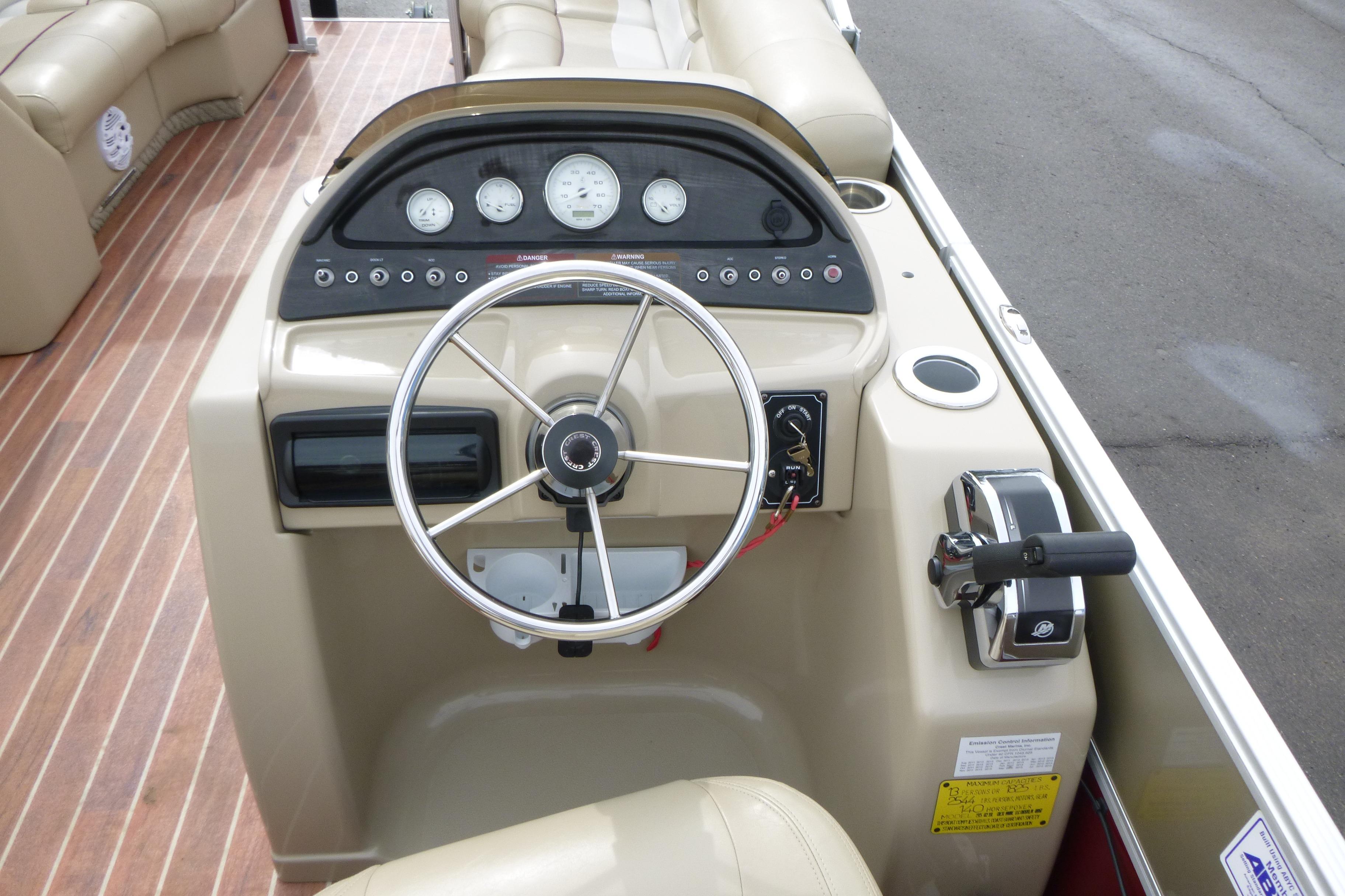 Steering console of a 2012 Crest 230SLR Classic boat with gauges and controls.