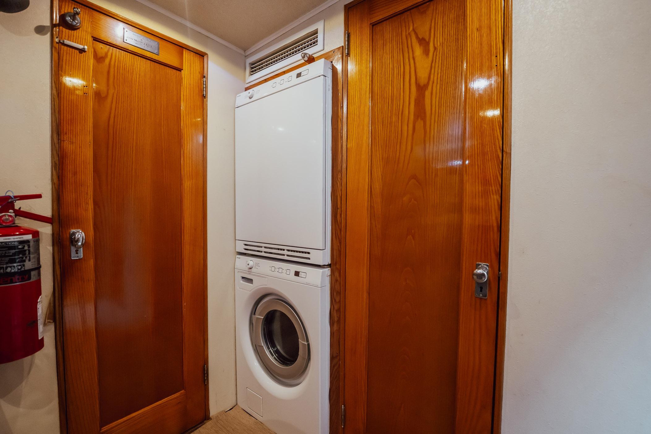 Laundry area with stacked washer-dryer in 1972 Trumpy 72 Motor Yacht.