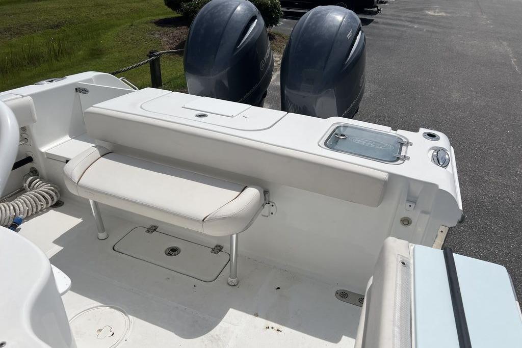 2021 Sea Hunt Gamefish 25 boat interior with seating and dual outboard motors.