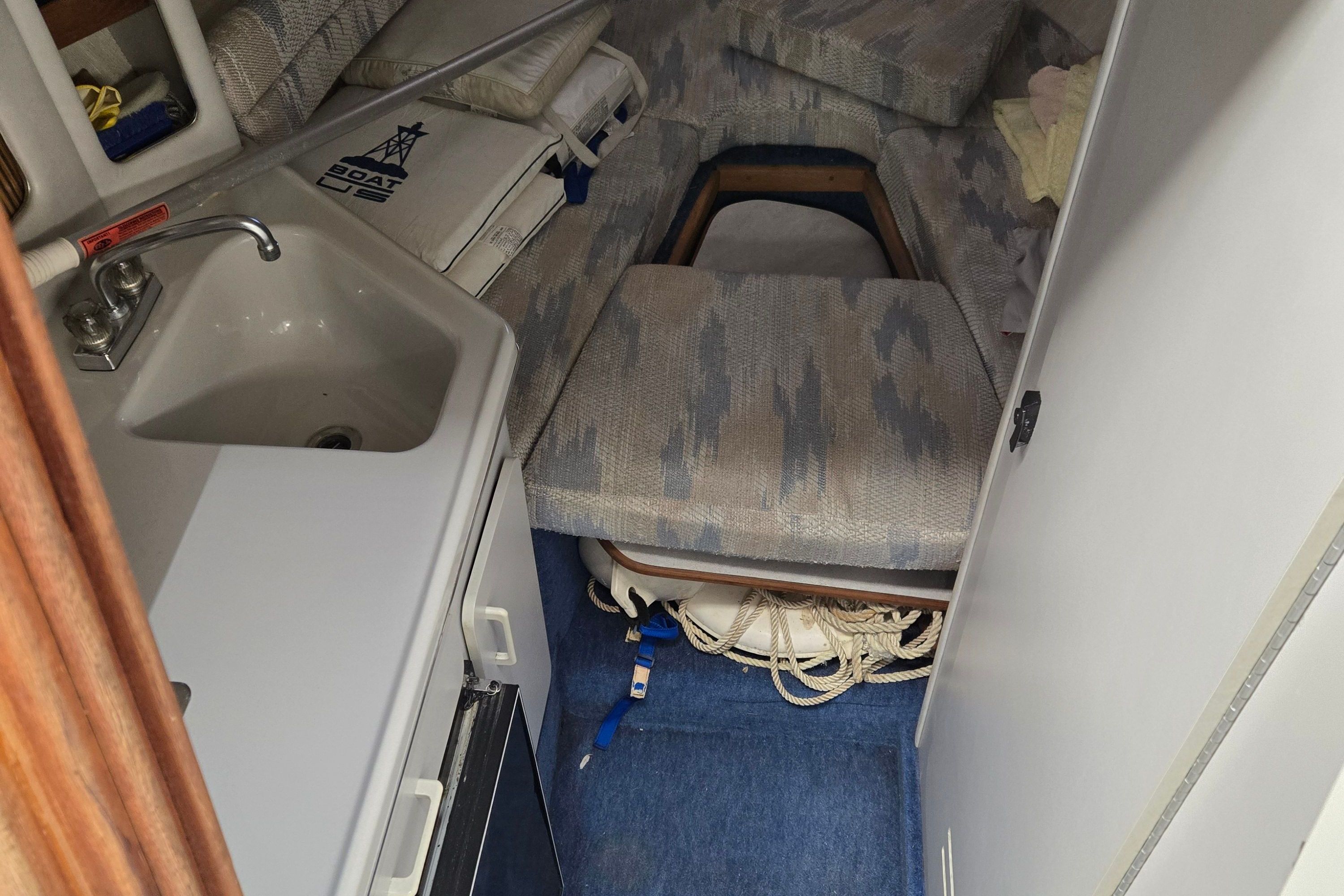 Interior of a 1991 Sea Ray 250 Weekender with sink and sleeping area.