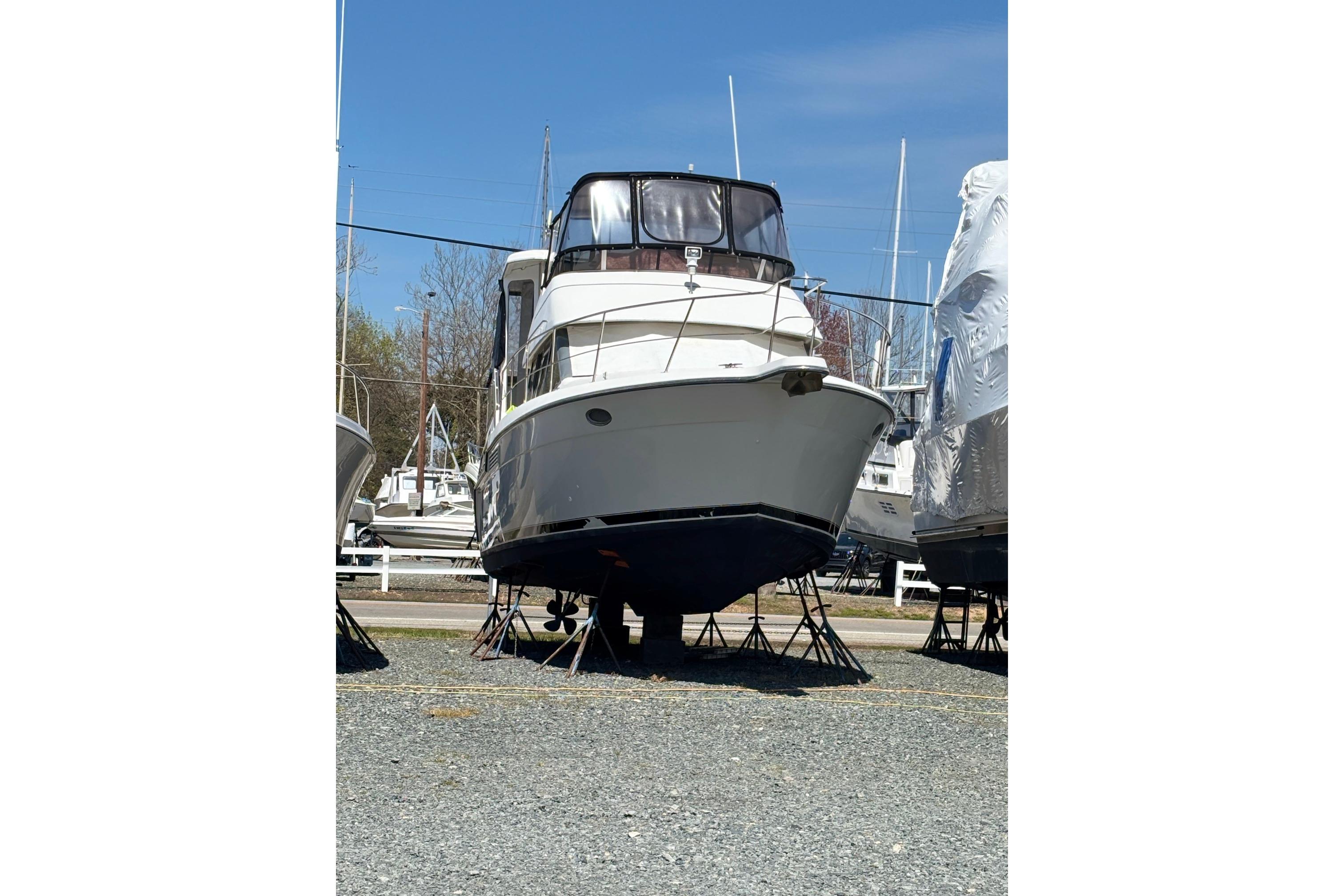 1995 Carver 356 Aft Cabin Motor Yacht on stands in a boatyard.