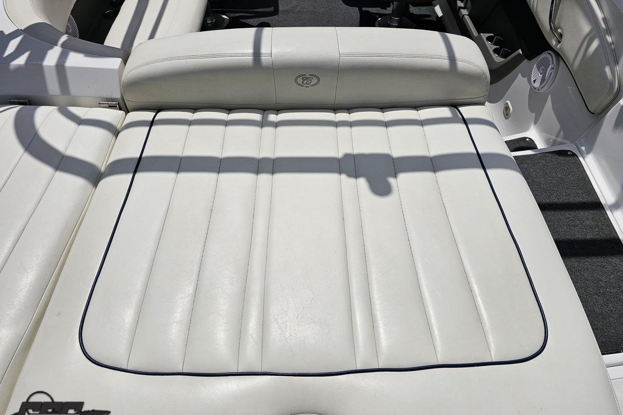 White leather seating on a 2010 Cobalt 232 WSS boat, featuring elegant stitching.