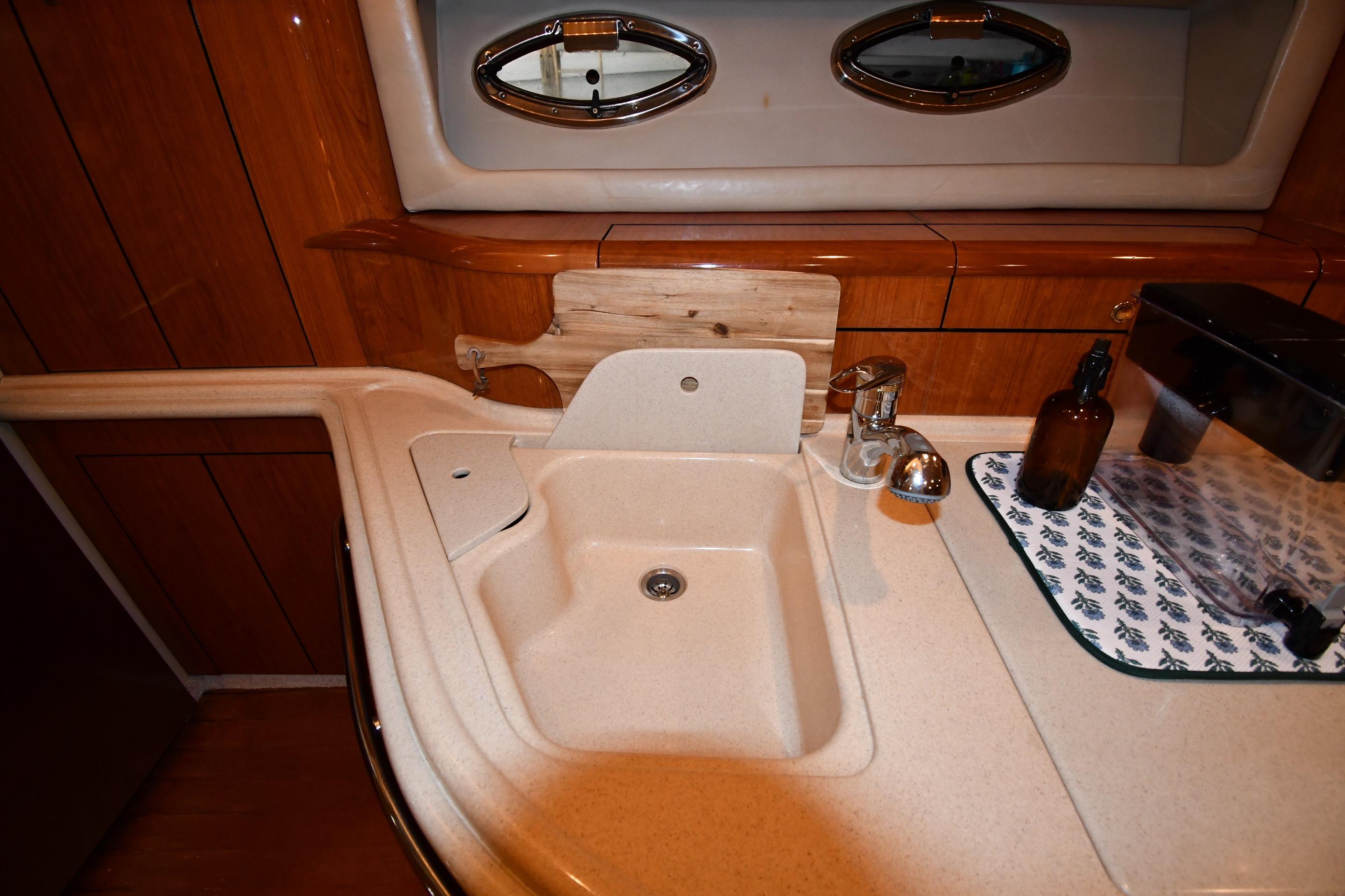 Luxurious 2001 Sea Ray 540 Sundancer yacht interior with elegant sink and wooden cabinetry.