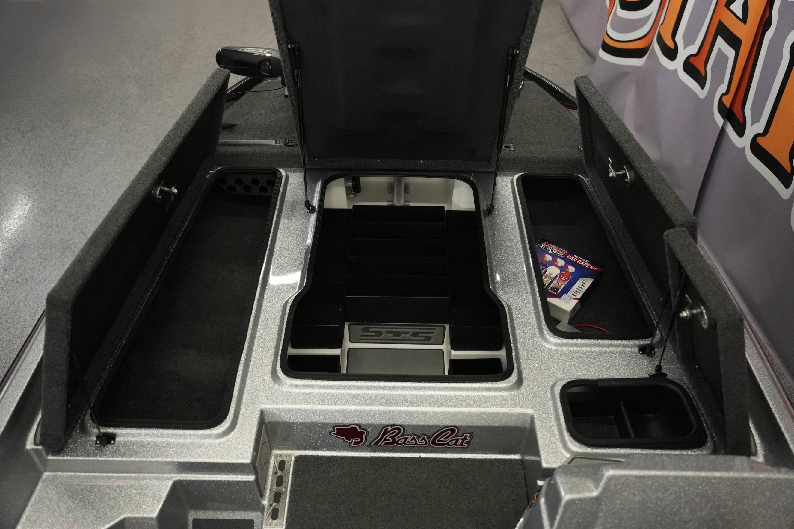 2026 Bass Cat Lynx STS boat storage compartments with open lids and organized interior.