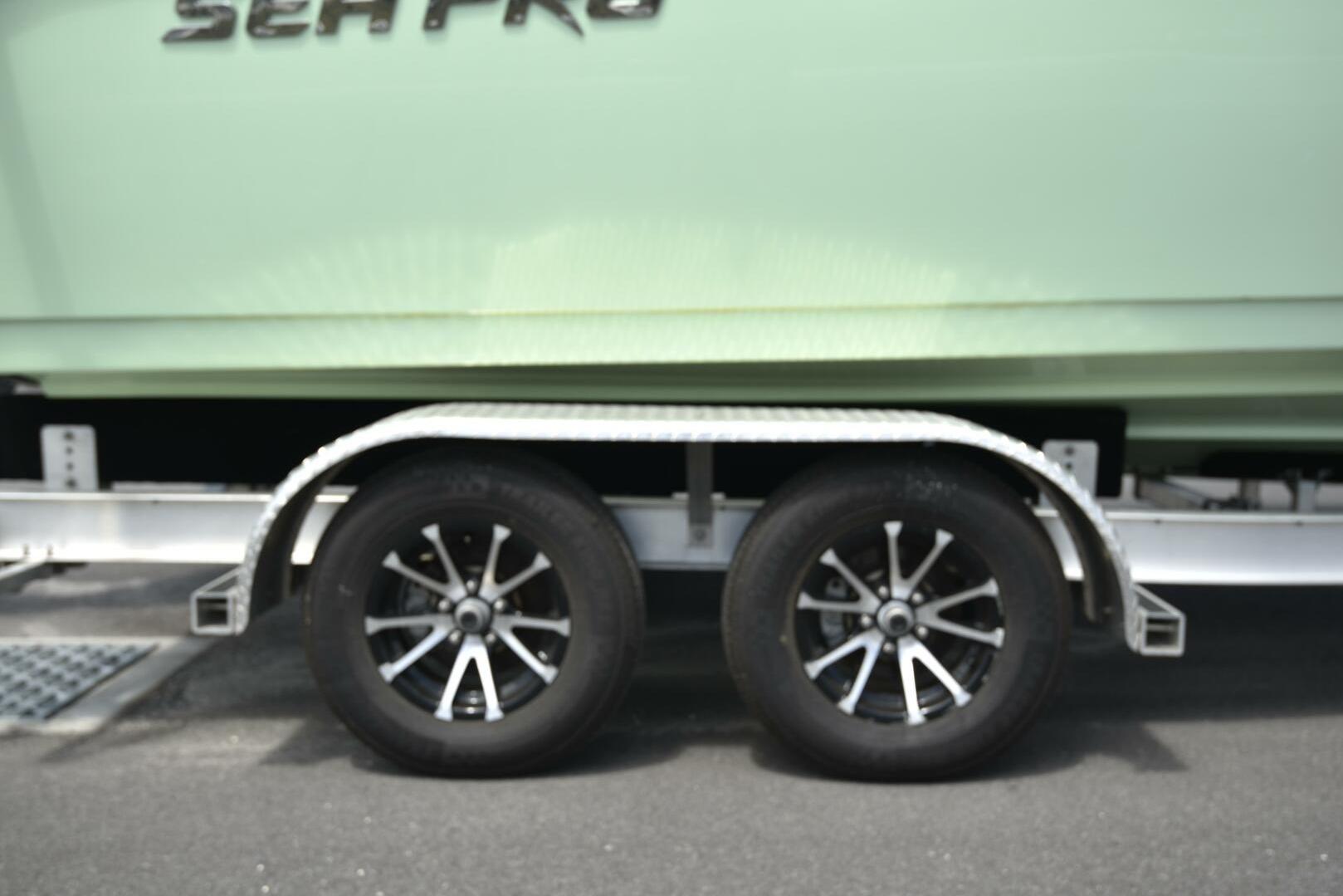 2023 Sea Pro 239 Deep V CC boat on trailer with dual wheels.