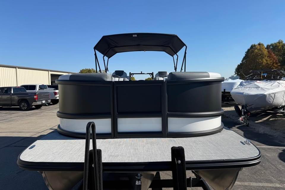 2026 Alera M 25Q pontoon boat with canopy, parked outdoors on a sunny day.